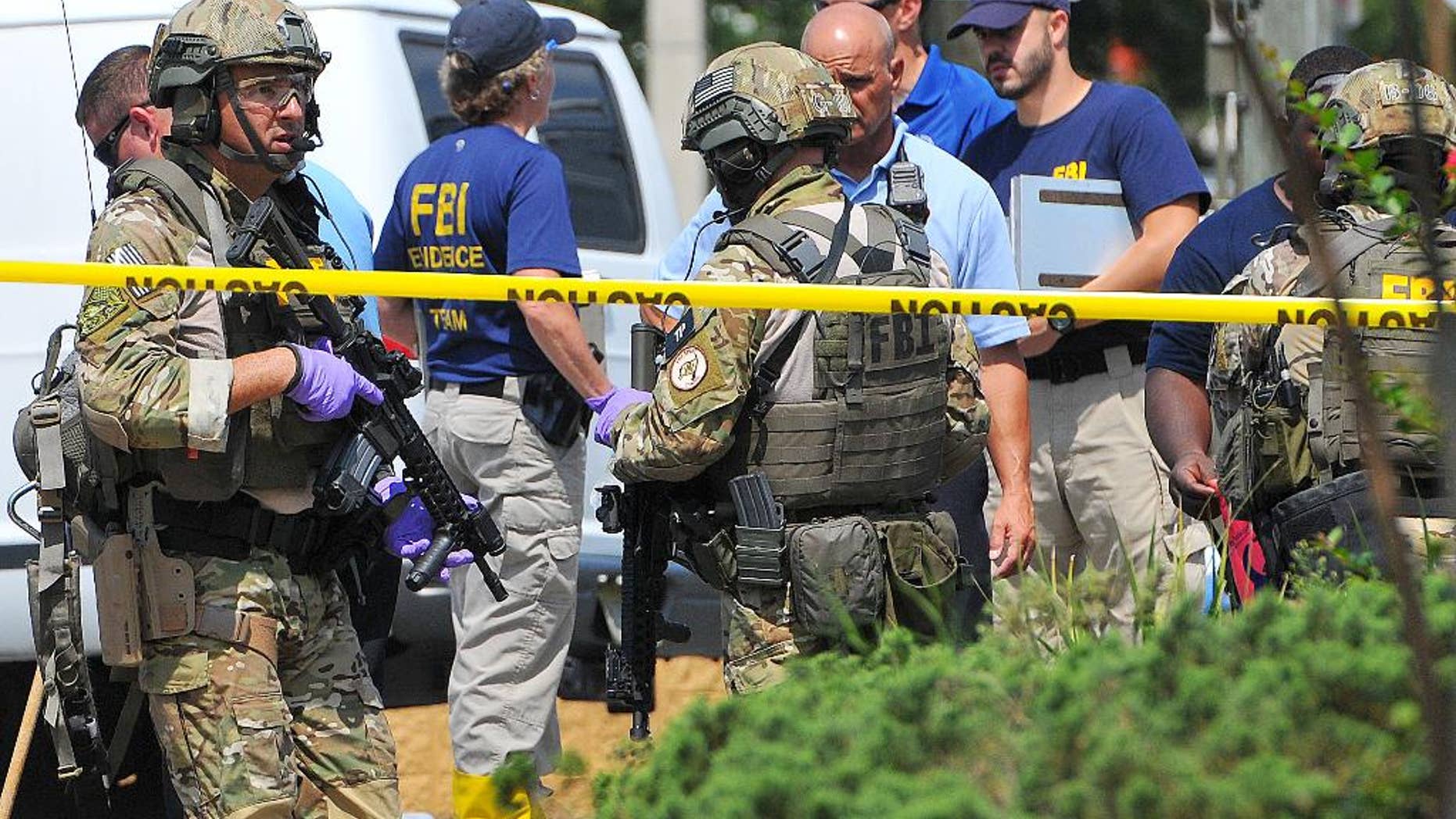 FILE - In this June 12, 2016 file photo, FBI, Orlando Police Department and personnel from the Orange County Sheriff's Office investigate the attack at the Pulse nightclub in Orlando, Fla. New reports show that law enforcement officials immediately suspected terrorism and adjusted their staging areas due to fears about an explosive device as they responded to reports of shots fired at the gay nightclub in Orlando. In incident reports released Saturday, June 25, Orange County Sheriff's Office deputies describe receiving limited information about an "active shooter" as they rushed to control the chaos outside Pulse on June 12. (Craig Rubadoux/Florida Today via AP, File) NO SALES; MANDATORY CREDIT