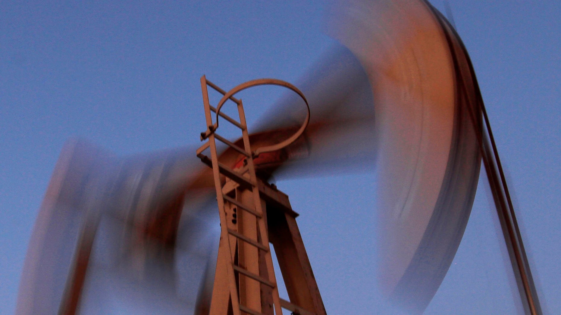 In this Thursday, March 7, 2013, photo, an oil pump works at sunset in the desert oil fields of Sakhir, Bahrain. The price of oil dropped more than 2 percent Wednesday, May 1, 2013 after disappointing economic news from the world’s two biggest oil-consuming nations. Benchmark oil for June delivery was down $2.40, or 2.6 percent, to $91.06 a barrel in morning trading on the New York Mercantile Exchange. (AP Photo/Hasan Jamali)