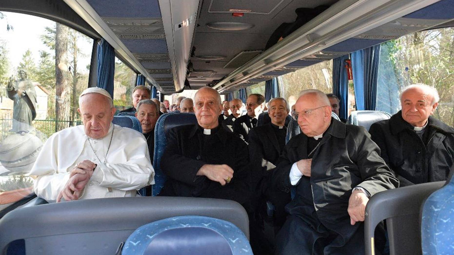 Pope Francis sits on a bus with members of the Roman on their way back to the Vatican at the end of a week long spiritual retreat at the village of Ariccia, near Rome, Friday, March 10, 2017. (L'Osservatore Romano/Pool Photo via AP)