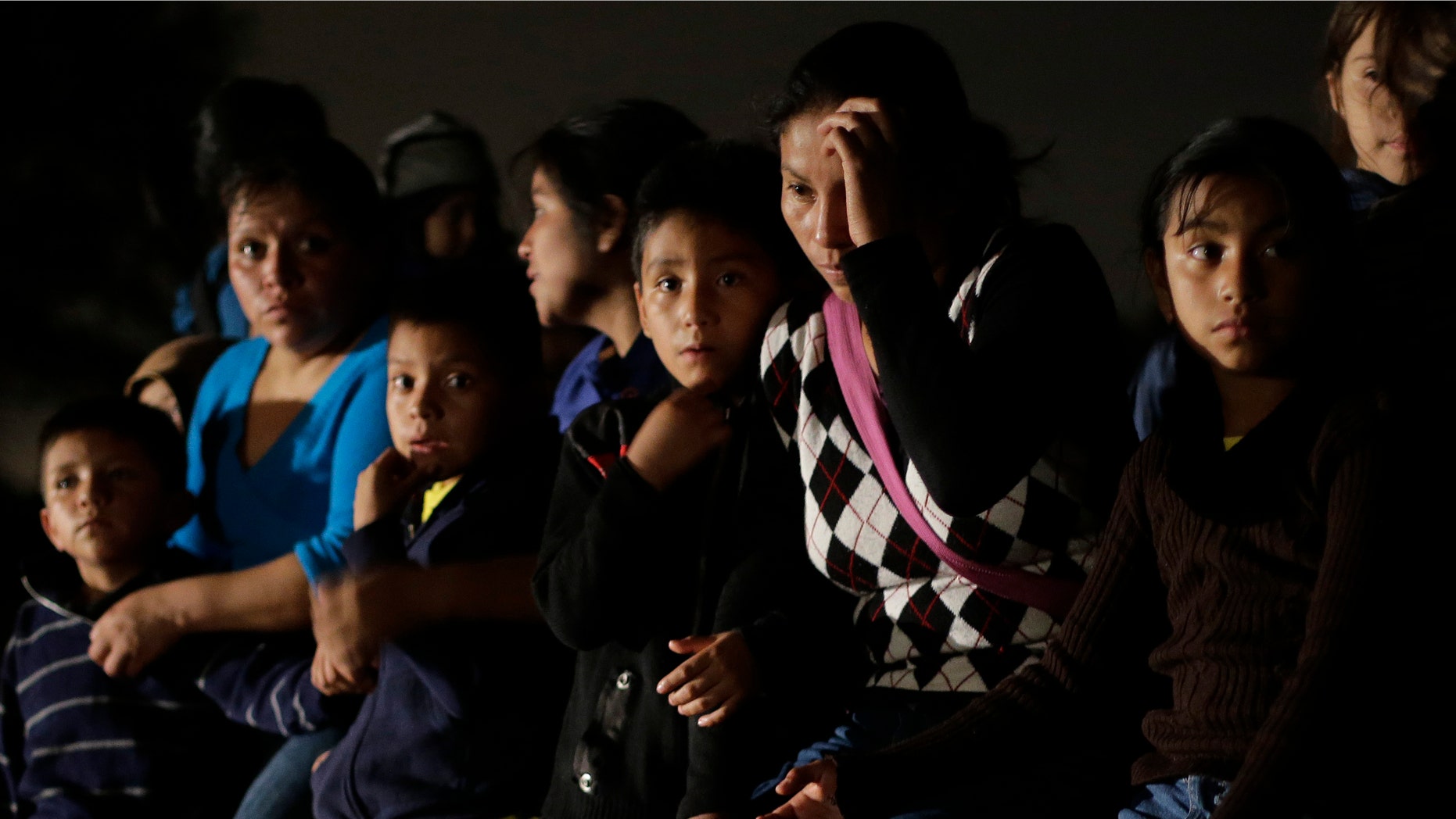 FILE - In this June 25, 2014 photo shows a group of immigrants from Honduras and El Salvador who crossed the U.S.-Mexico border illegally are stopped in Granjeno, Texas. The influx at the border is largely families with children or by minors traveling alone. From October 2012 through the end of September 2013, the U.S. Border Patrol apprehended about 24,000 unaccompanied children. But between October and the end of June 2014, the number shot up to 57,000. Secretary of Homeland Security Jeh Johnson testified recently that the number is accelerating so fast that it could reach 90,000 by the end of September. Most of them are coming from El Salvador, Honduras and Guatemala. (AP Photo/Eric Gay, File)