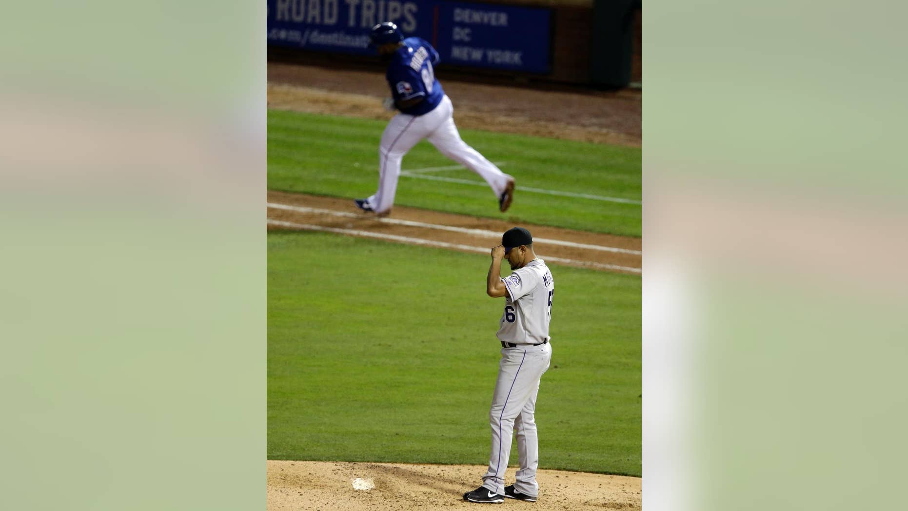 Colorado Rockies starting pitcher Franklin Morales (56) lowers the bill of his cap over his face as Texas Rangers' Prince Fielder rounds first on a solo home run off of Morales in the sixth inning of a baseball game, Thursday, May 8, 2014, in Arlington, Texas. The Rangers won 5-0. (AP Photo/Tony Gutierrez)