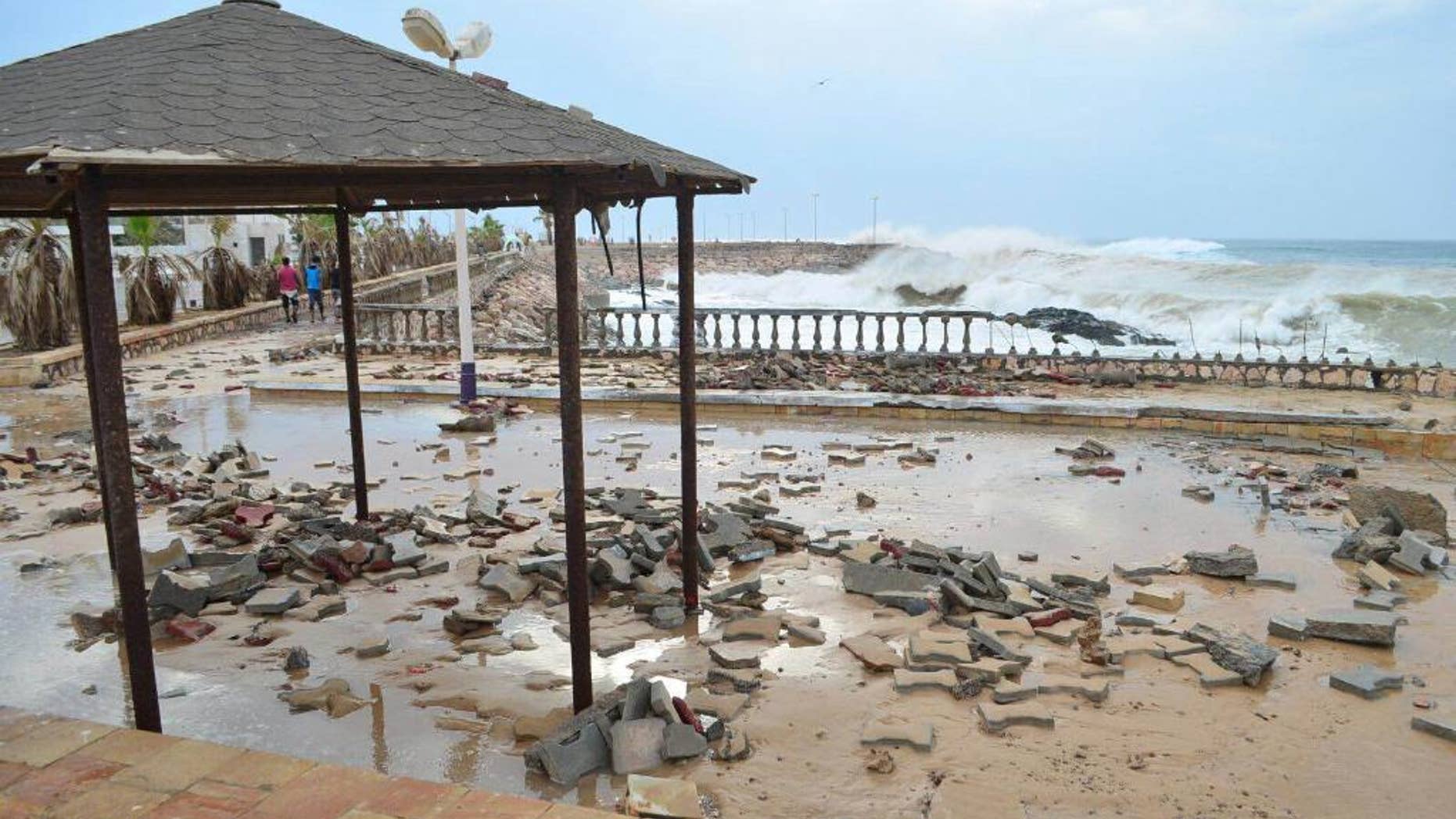 FILE - In this Monday, Nov. 2, 2015 file photo, A tropical Cyclone Chapala batters Mukalla, Yemen. Yemen's Islamic State affiliate claimed responsibility for a suicide car bombing that struck a coast guard base in the southern port city of Mukalla at dawn Thursday, May 12, 2016 killing at least six troops in the first major attack in a city once occupied by its rival group, al-Qaida. (AP Photo/Mohammed Bazahier, File)