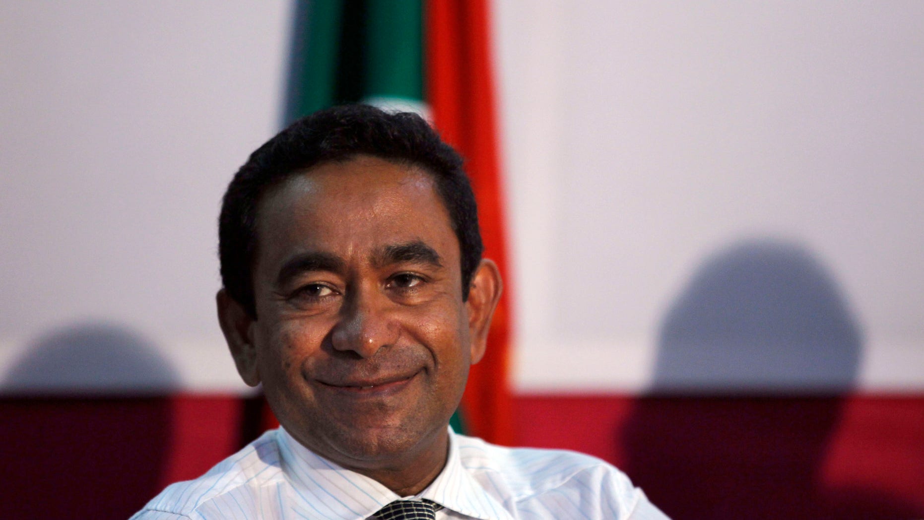 In this late Saturday, Nov. 16, 2013 photo, Maldives' Yaamin Abdul Gayoom, brother of former autocrat Maumoon Abdul Gayoom smiles during a press conference in Male, Maldives. Voters in the Maldives have chosen the brother of the archipelago nation's former strongman to be their new president over the country's first democratically elected leader in a closely fought runoff election on Saturday. (AP Photo/Sinan Hussain)
