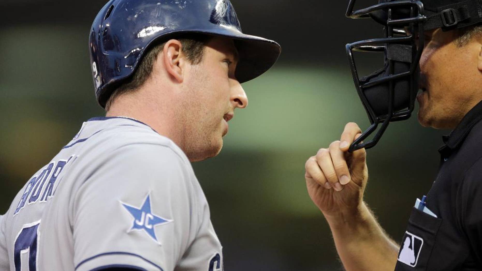 San Diego Padres' Jedd Gyorko, left, questions plate umpire Mike DiMuro after he was called out on strikes in the fourth inning of a baseball game against the Minnesota Twins, Tuesday, Aug. 5, 2014, in Minneapolis. (AP Photo/Jim Mone)