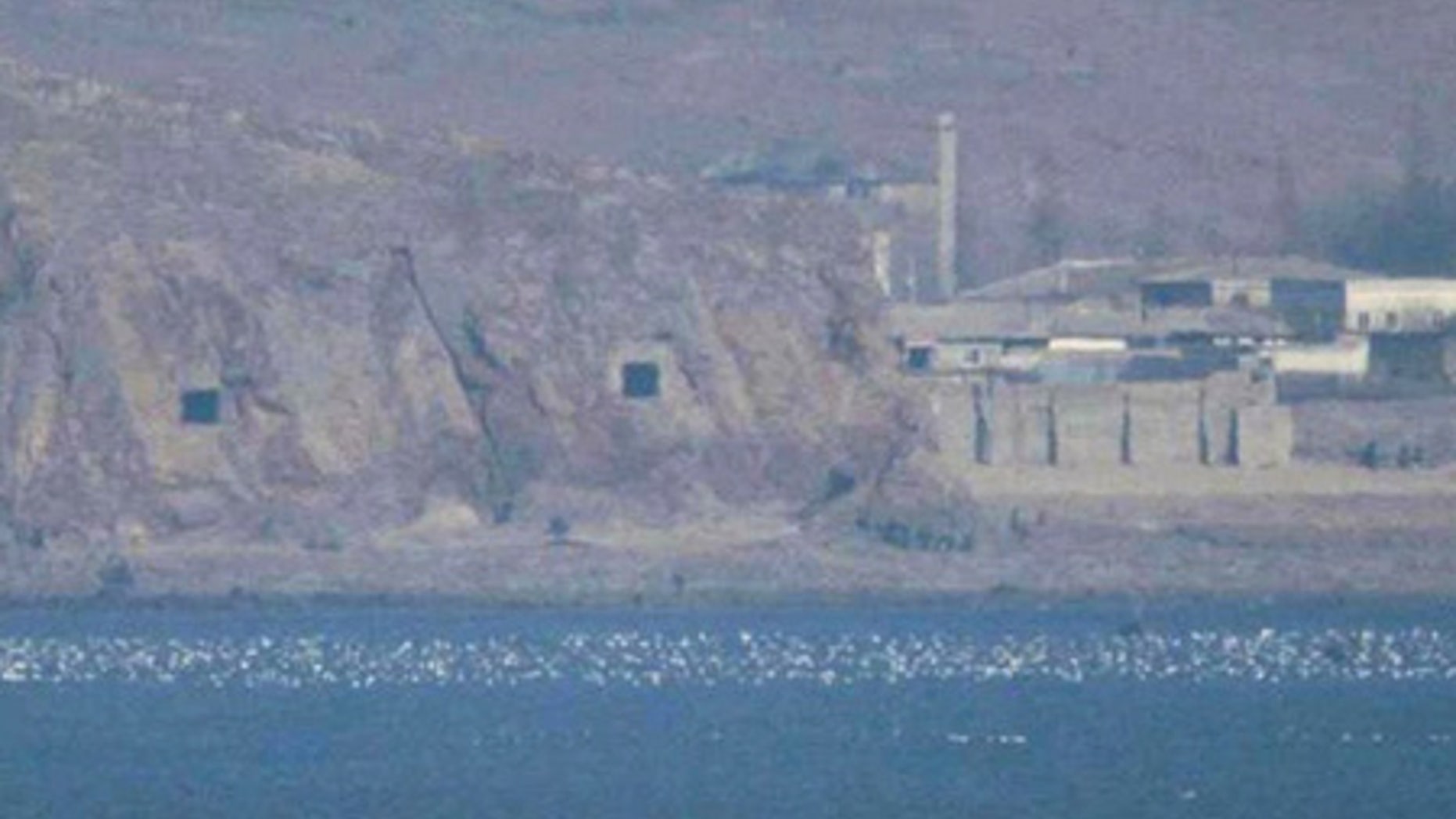 FILE: Two caves with coastal artillery, left, are seen at the North Korean village of Haeju where North Korea's military units are stationed.