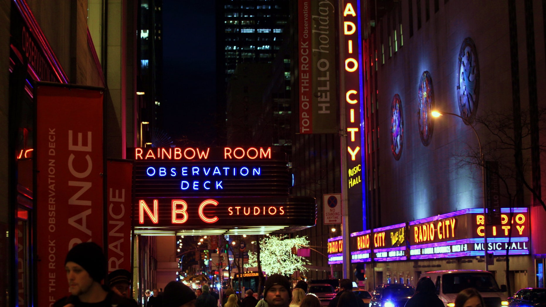 FILE - In this Friday, Aug. 21, 2009, file photo, the NBC logo glows in neon lights among other iconic signs at its headquarters in New York. Comcast said Tuesday, Feb. 12, 2013, that it's buying General Electric's 49 percent stake in the NBCUniversal joint venture for $16.7 billion several years early, as the company takes advantage of low borrowing costs and what CEO Brian Roberts called a "very attractive price." (AP Photo/Bebeto Matthews, File)