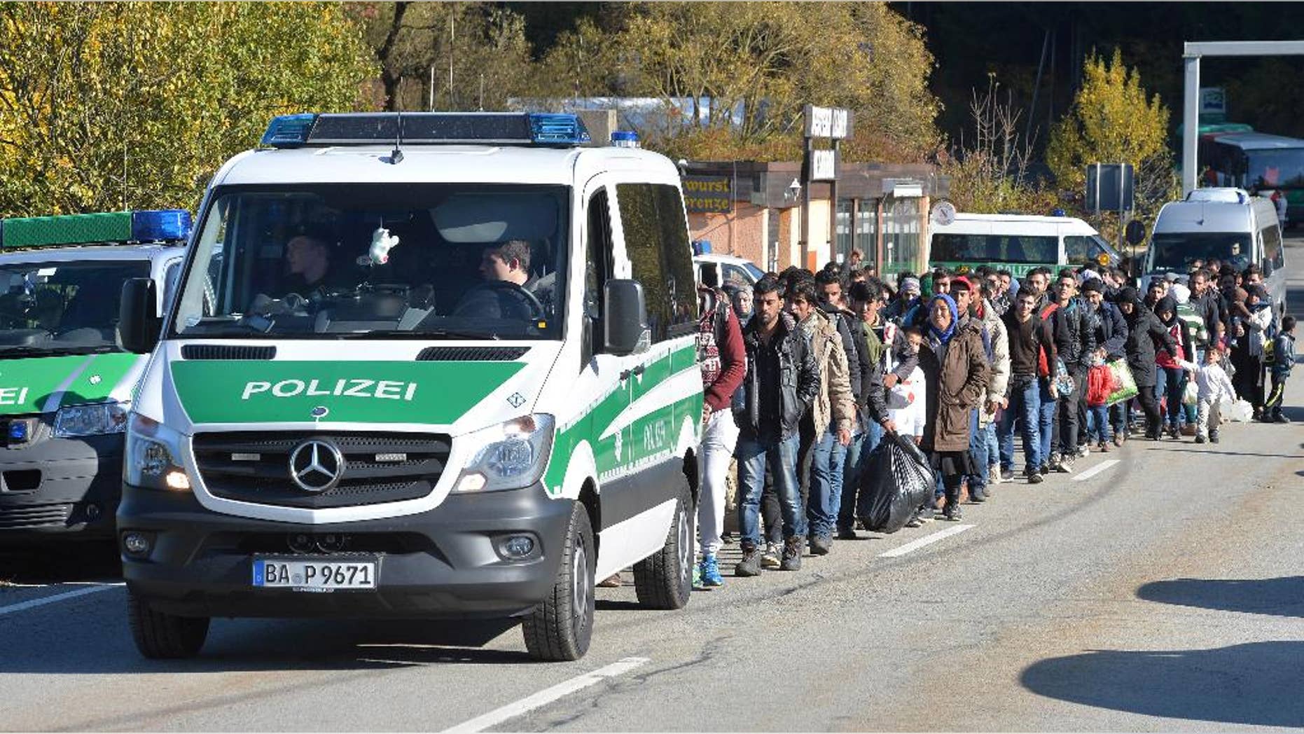 German federal police guide a group of migrants on their way.
