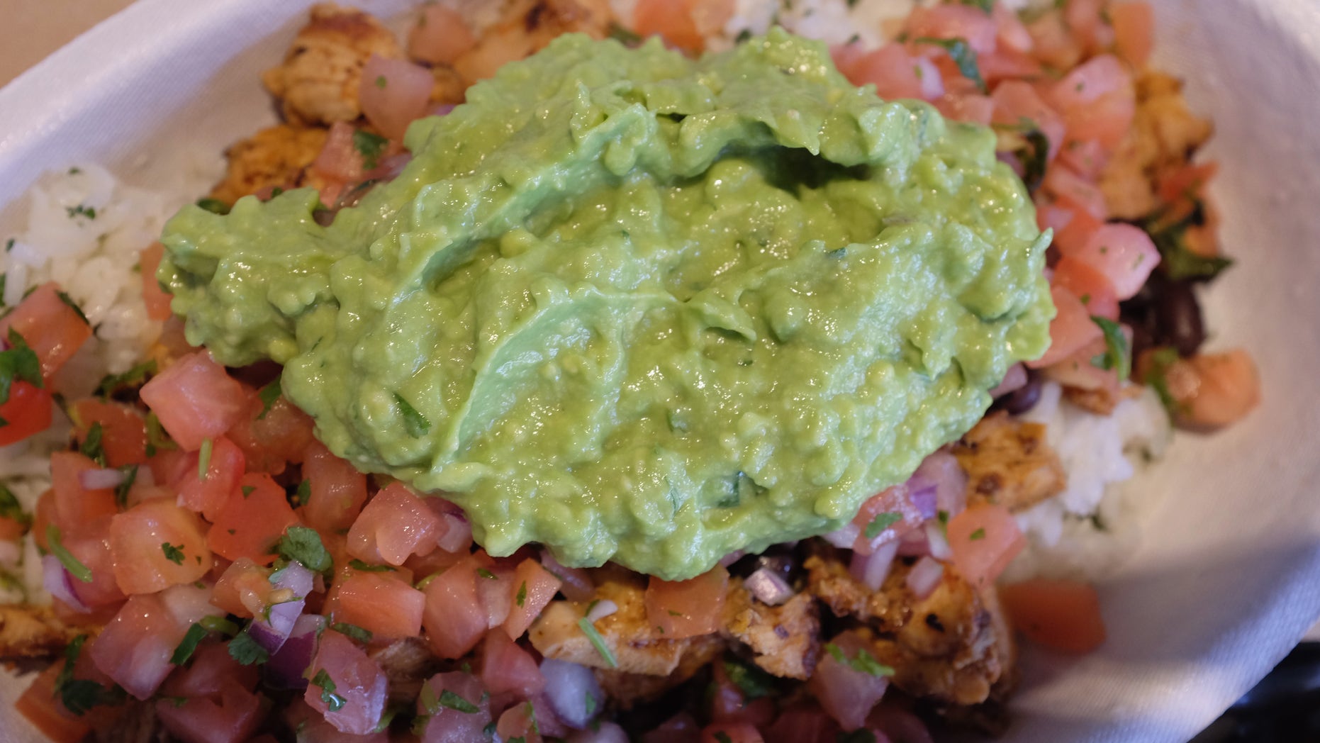 MIAMI, FL - MARCH 05: Guacamole sits on a dish at a Chipotle restaurant on March 5, 2014 in Miami, Florida. The Mexican fast food chain is reported to have tossed around the idea that it would temporarily suspend sales of guacamole due to an increase in food costs. (Photo by Joe Raedle/Getty Images)