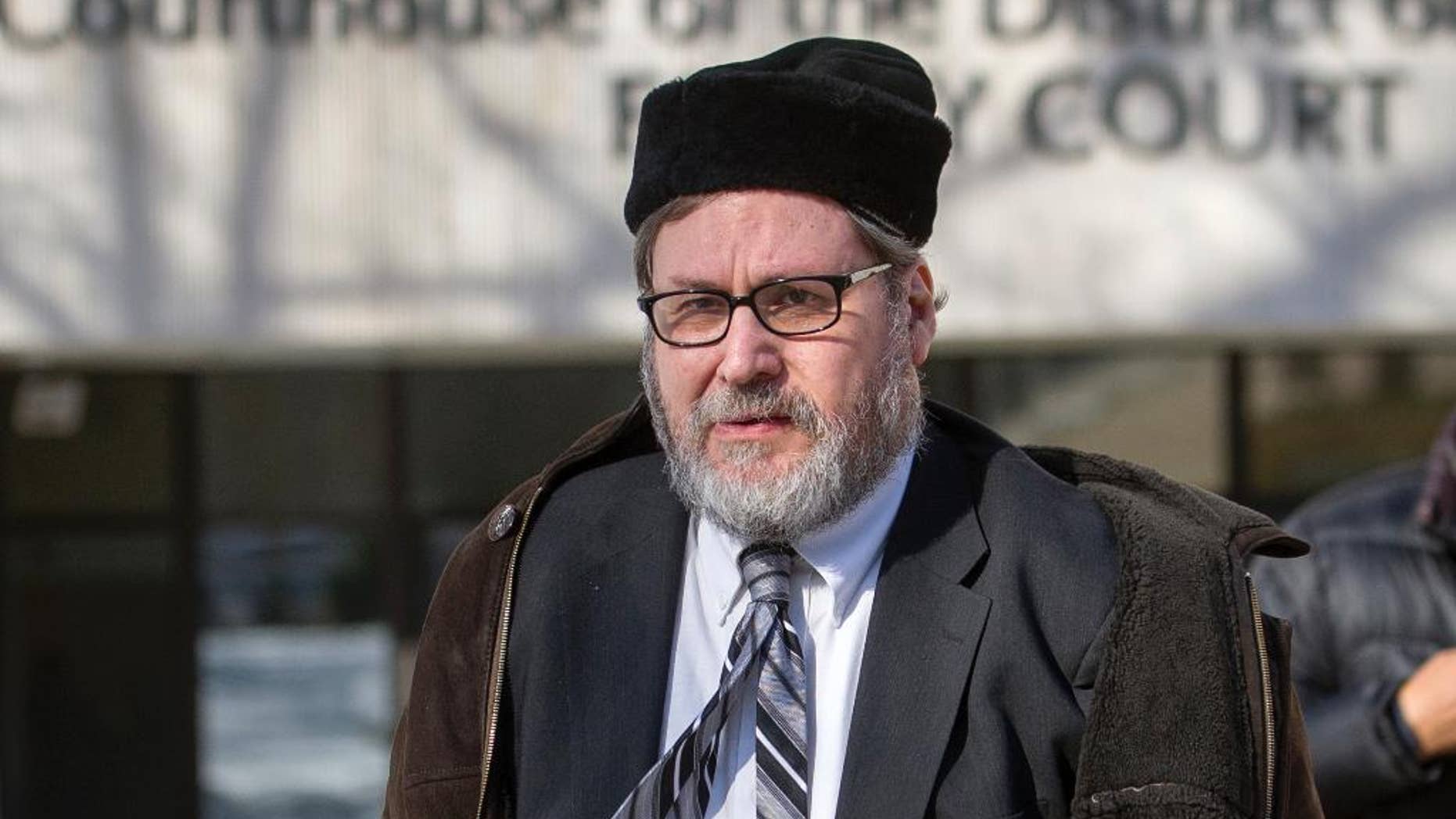 FILE - In this Feb. 19, 2015 file photo, Rabbi Bernard Freundel leaves the D.C. Superior Court House in Washington. Freundel, A once-prominent Orthodox rabbi who pleaded guilty to secretly videotaping nude women at a Jewish ritual bath in Washington was given a lawful sentence when he was sentenced to approximately 6 ½ years in prison, an appeals court ruled Thursday, Sept. 15, 2016. (AP Photo/Cliff Owen, File)