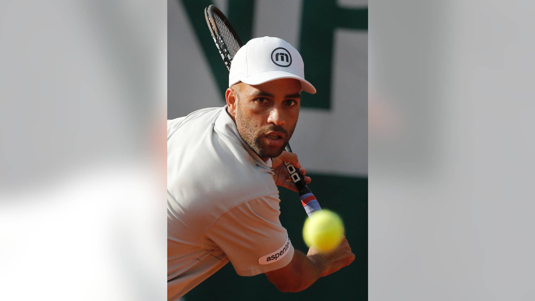 FILE - In this May 26, 2013, file photo, James Blake makes a return against Serbia's Viktor Troicki in their first round match of the French Open tennis tournament in Paris. New York City's police commissioner says he's been trying to apologize to former tennis professional James Blake, who was handcuffed by officers after a case of mistaken identity. Blake says he was standing outside a Manhattan hotel Wednesday, Sept. 9, 2015, waiting to head to the U.S. Open when an officer charging him. He says he was body-slammed and handcuffed. (AP Photo/Michel Spingler, File)