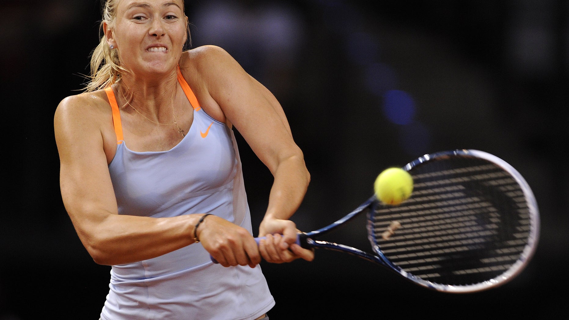 Russia's Maria Sharapova returns a shot to Serbia's Ana Ivanovic during their quarter final match at the Porsche tennis GP in Stuttgart, Germany, Friday, April 26, 2013. Sharapova won the match with 7-5,4-6 and 6-4. (AP Photo/dpa, Daniel Maurer)