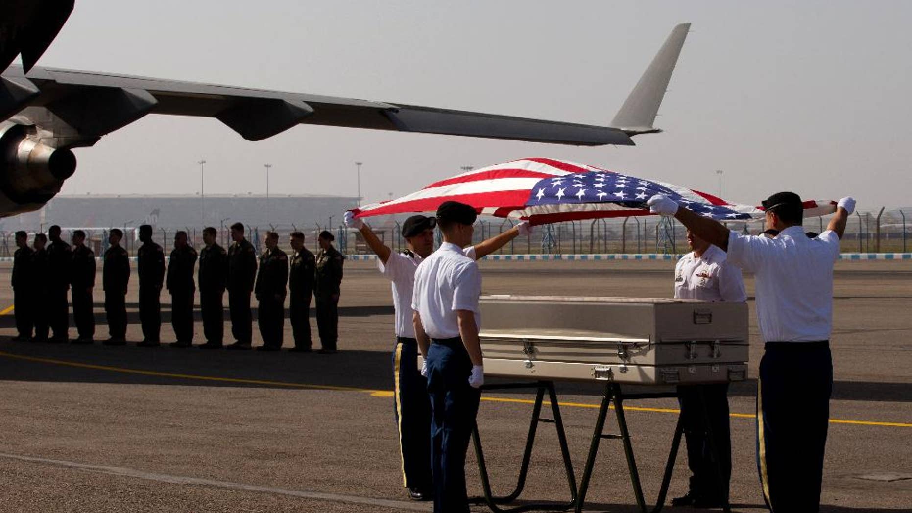 APRIL 13: U.S. military members pay final respects to what they believe may be the remains of one to two crew members from a B-24 bomber that crashed during World War II at a ceremony at the Palam airport.