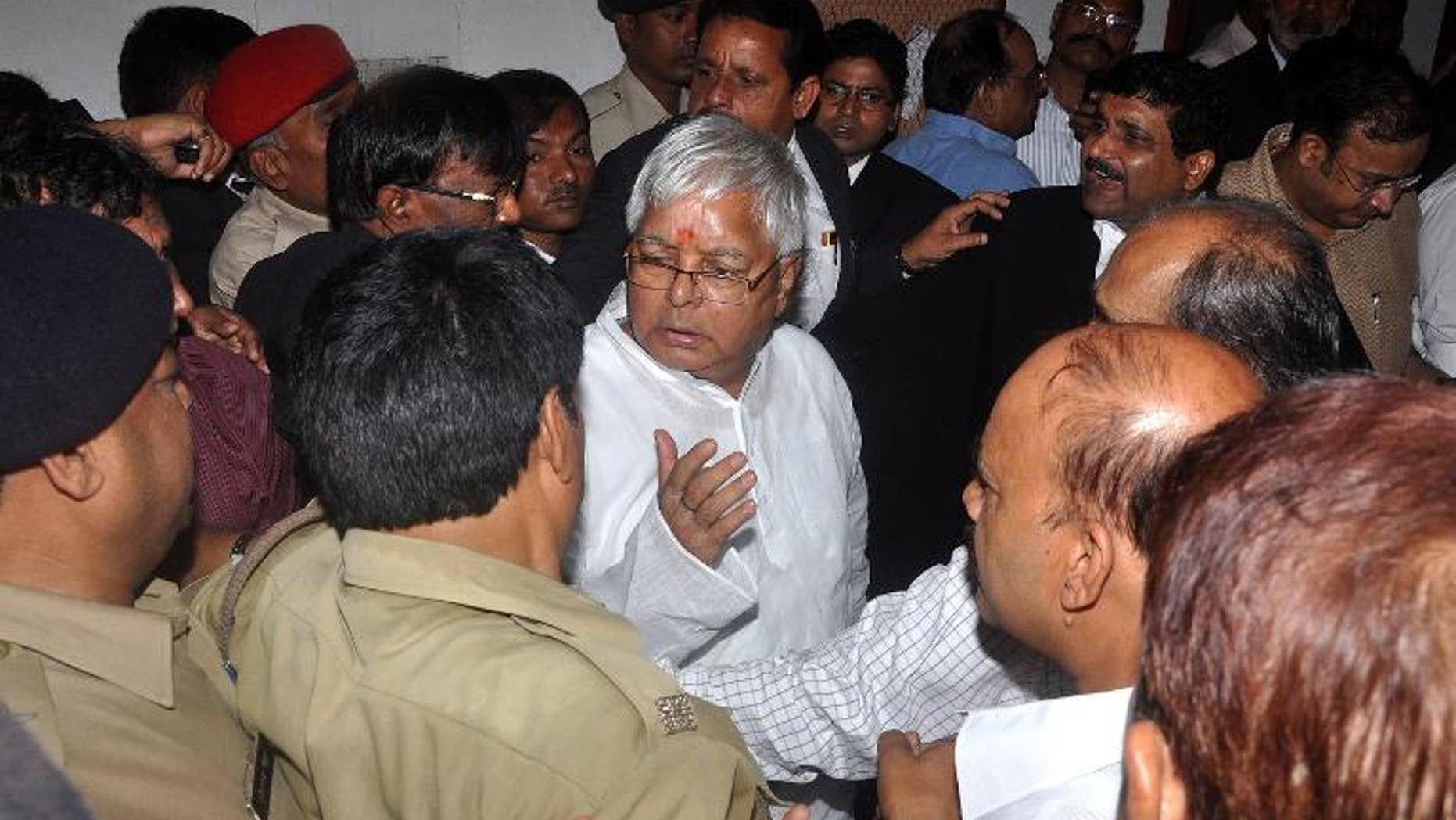 Lalu Prasad Yadav (centre) is escorted out of court after a hearing in Ranchi, Jharkhand, on September 30, 2013