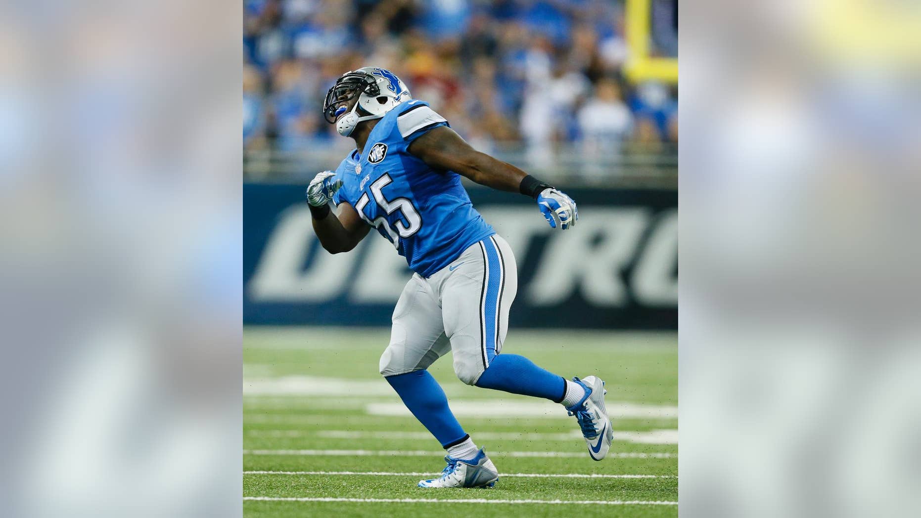 Detroit Lions middle linebacker Stephen Tulloch (55) celebrates his sack of Green Bay Packers quarterback Aaron Rodgers (12) during the first half of an NFL football game in Detroit, Sunday, Sept. 21, 2014. Tulloch injured his left knee celebrating. (AP Photo/Rick Osentoski)