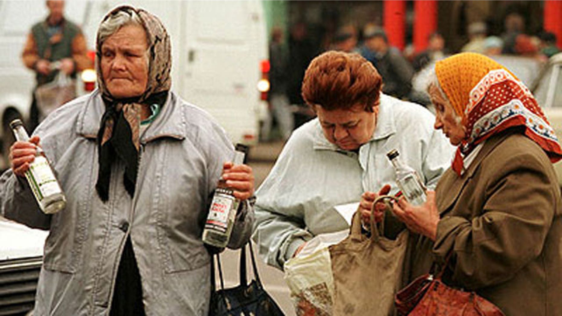 Elderly women sell cheap vodka on a street in Moscow