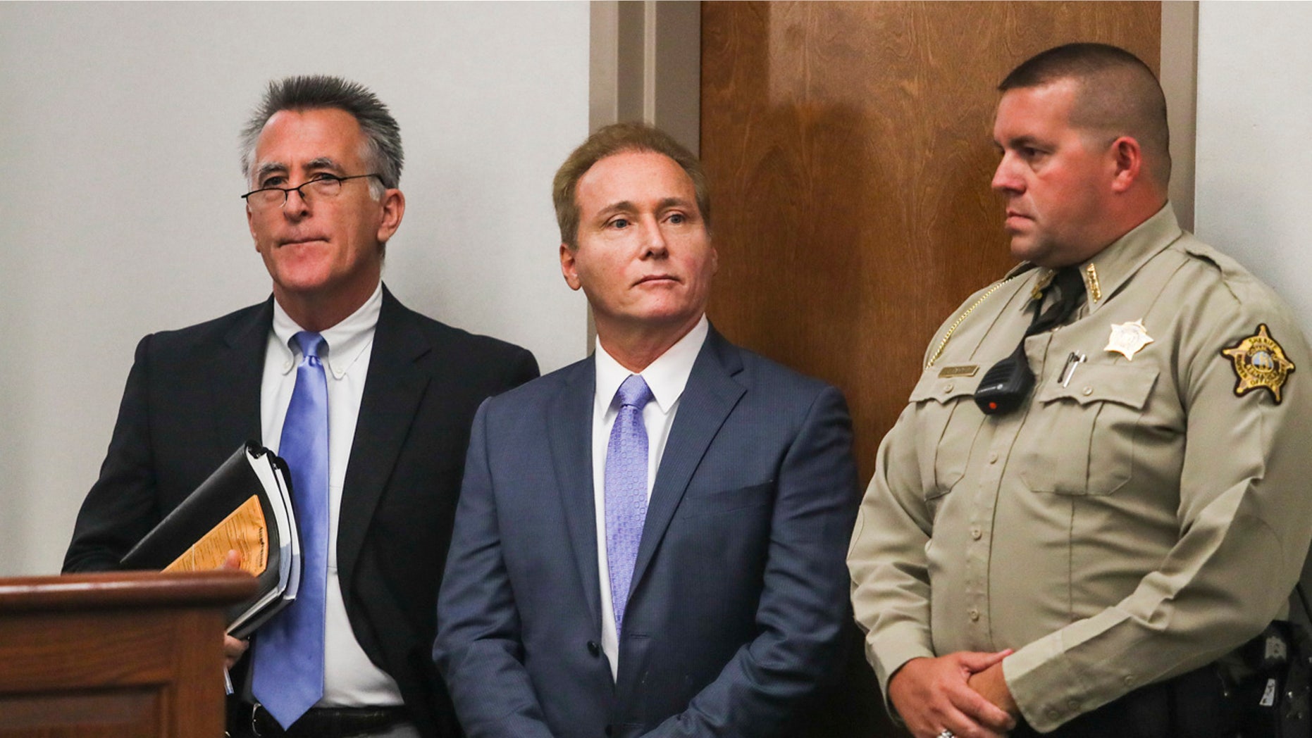 In this Nov. 9 photo, Rene Boucher, center, appears in court for an arraignment hearing with his attorney, Matt Baker, left, at the Warren County Justice Center in Bowling Green, Kentucky.