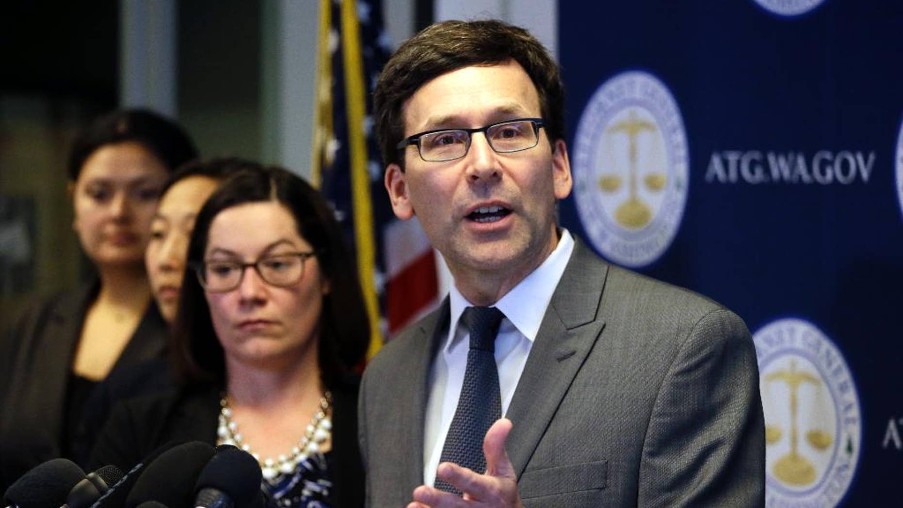 FILE--In this March 9, 2017, file photo, Washington State Attorney General Bob Ferguson speaks at a news conference about the state's response to President Trump's revised travel ban in Seattle, Wash. Ferguson has asked a federal judge for a Tuesday, March 14, 2017, hearing on the case. (AP Photo/Elaine Thompson, file)
