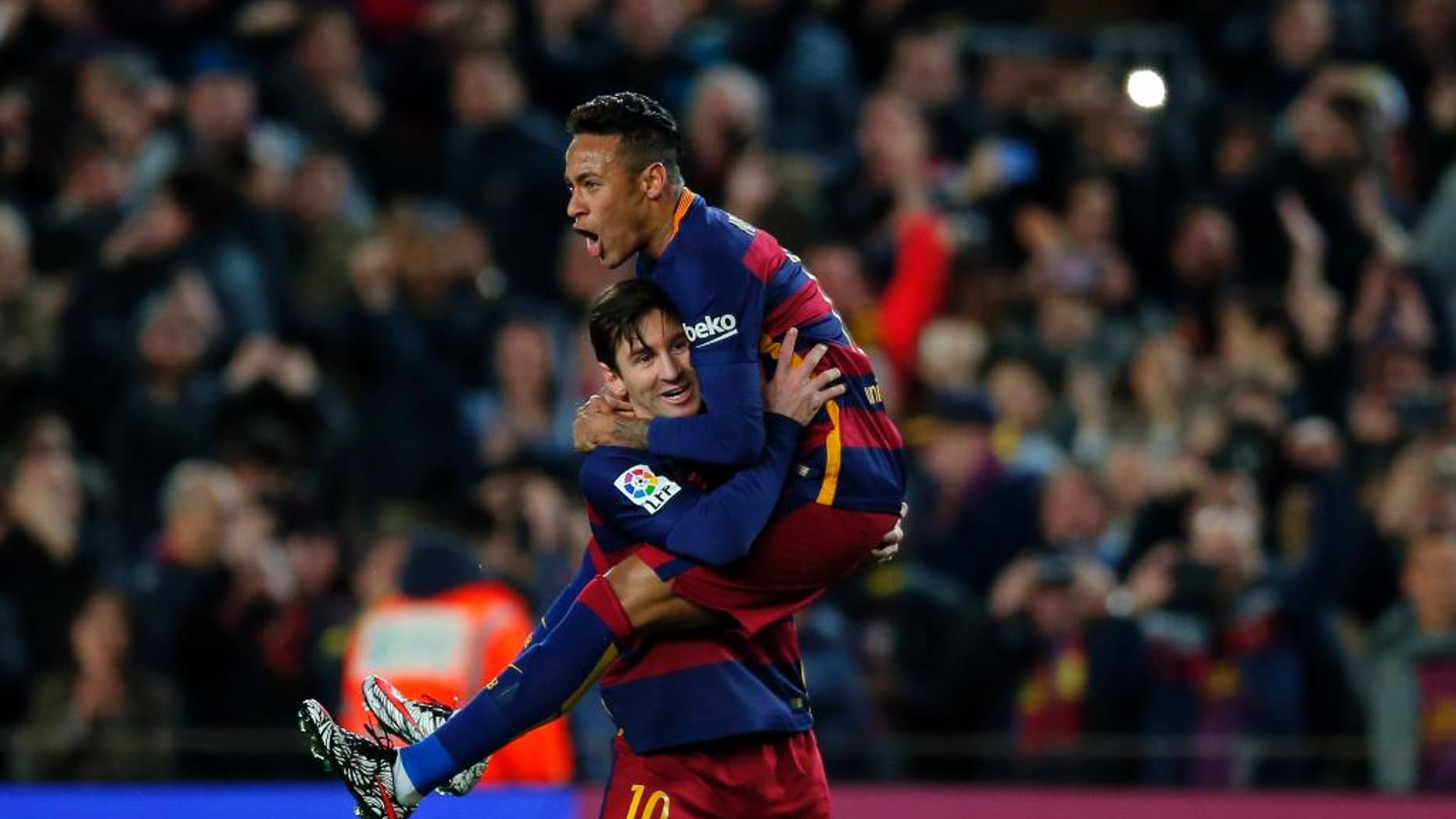 FILE - In this Feb. 28, 2016, file photo, FC Barcelona's Lionel Messi, left, celebrates after scoring against Sevilla with his teammate Neymar during a Spanish La Liga soccer match at the Camp Nou stadium in Barcelona, Spain. Looking to capitalize on its biggest assets — superstars like Messi and Neymar — and the growing popularity of soccer in the U.S., Barcelona opened a commercial office in New York this week that will lead the team's efforts to expand its business, gain more fans across the Atlantic and help the sport grow in America. (AP Photo/Manu Fernandez File)