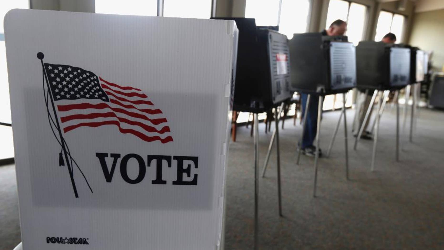 FILE - In this March 18, 2014 file photo, voters cast their ballots in the Illinois primary in Hinsdale, Ill. A Pew Research Center analysis of census data released on May 16, 2016, finds that millennials are now tied with baby boomers for the largest percentage share of eligible voters. (AP Photo/M. Spencer Green, File)
