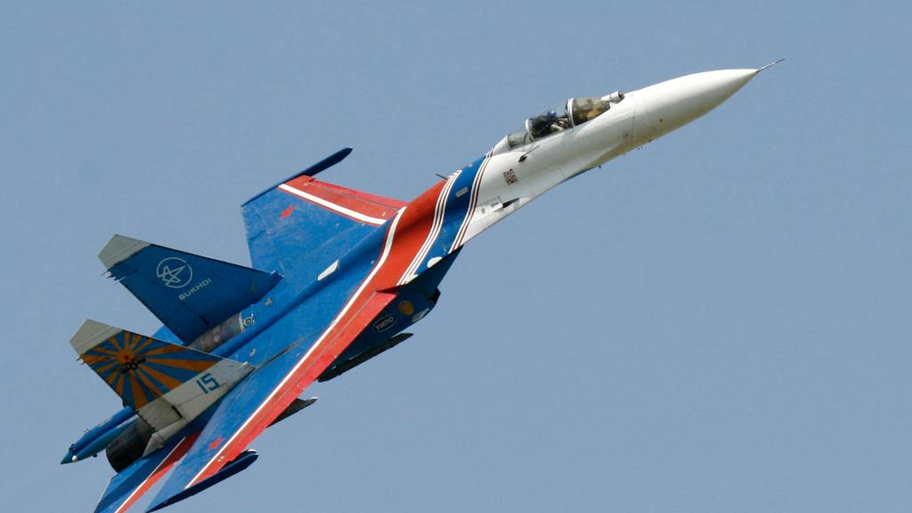 FILE- In this Saturday, May 26, 2007 file photo, a Sukhoi Su-27 fighter jet of the Russian air force elite aerobatic team Russkiye Vityazi (Russian Knights) makes a low pass during an air show in Rostov-on-Don, Russia. A pilot of the Russian air force's elite aerobatic squadron died Thursday, June 9, 2016 when his fighter jet crashed near Moscow. The Russian Defense Ministry said the Su-27 fighter jet went down while returning from a training mission. It said, according to preliminary information, the crash had been caused by a technical malfunction, but wouldn't elaborate pending an official probe. 3 (AP Photo/Sergei Venyavsky, file)
