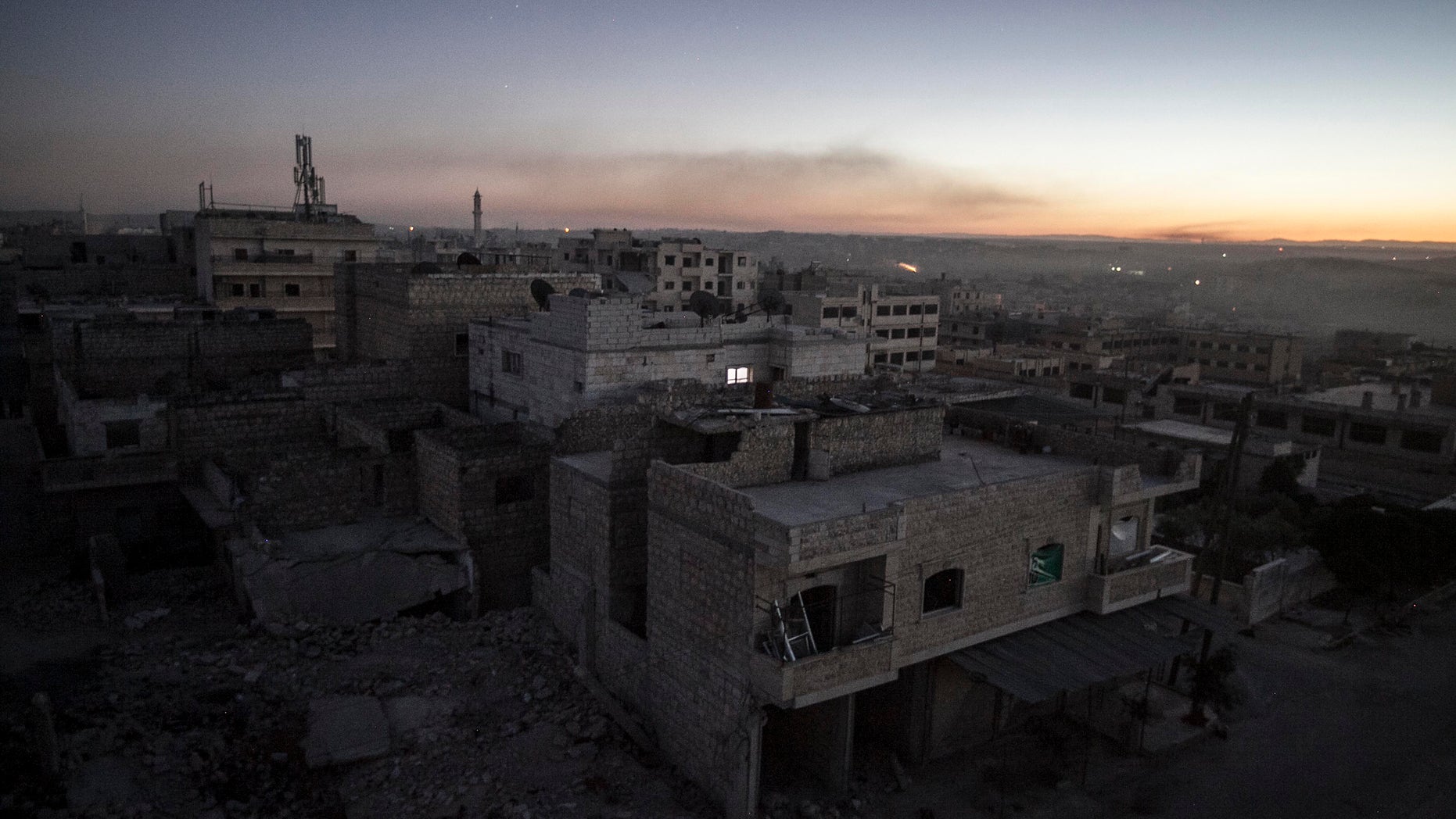 Smoke from burning tires set by opposition fighters overcasts what it used to be a residential area during their fighting against Syrian government forces in Maaret al-Numan in the Idlib province, Syria, Wednesday, Oct. 9, 2013. Rebels Wednesday overran a military post near the southern city of Daraa, according to the Britain-based Syrian Observatory for Human Rights activist group. Opposition fighters late last month also captured a nearby military base that previously served as the customs office on the outskirts of Daraa. (AP Photo)
