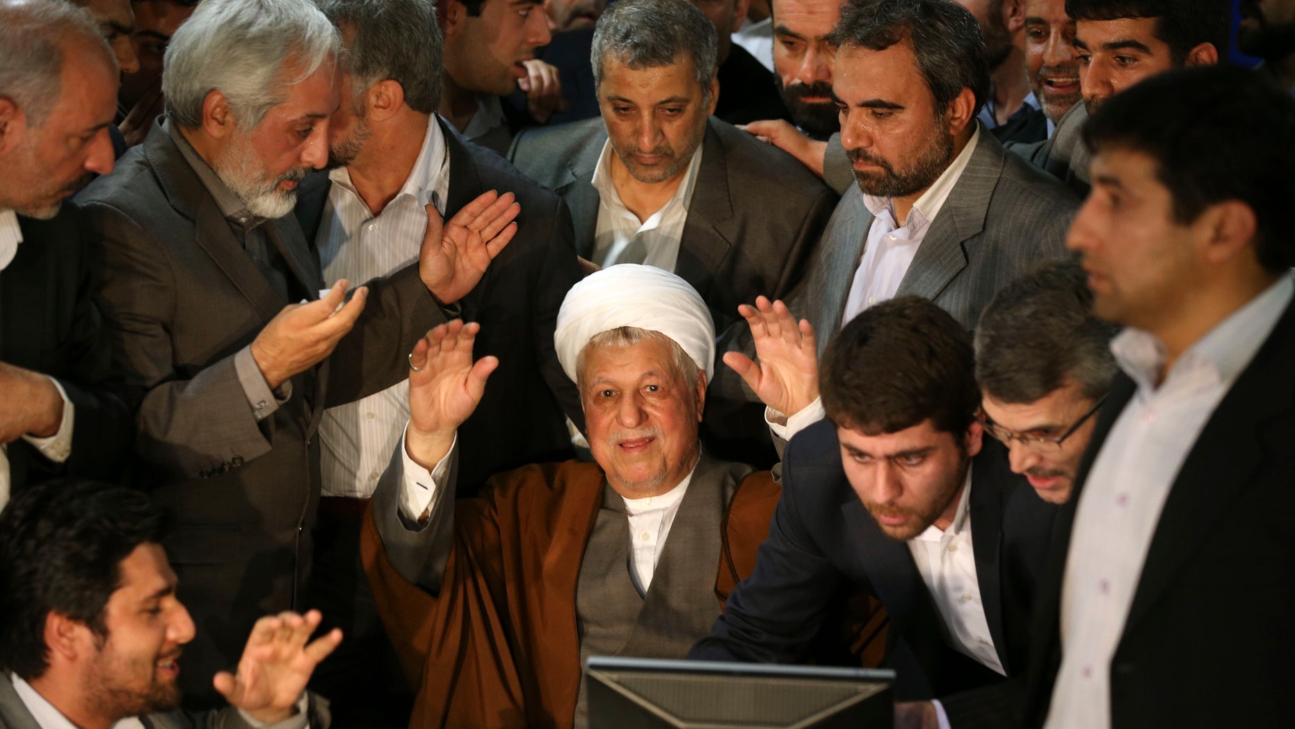 FILE -- In this Saturday, May 11, 2013 file photo, former Iranian President Akbar Hashemi Rafsanjani, 78, waves to media, as he registers his candidacy for the upcoming presidential election, at the election headquarters of the interior ministry in Tehran, Iran. Iran’s election overseers say they will bar physically weak hopefuls from running in next month presidential election, a direct hint at Rafsanjani. Iran's Constitution doesn't set any age limit for presidential candidates. (AP Photo/Ebrahim Noroozi, File)