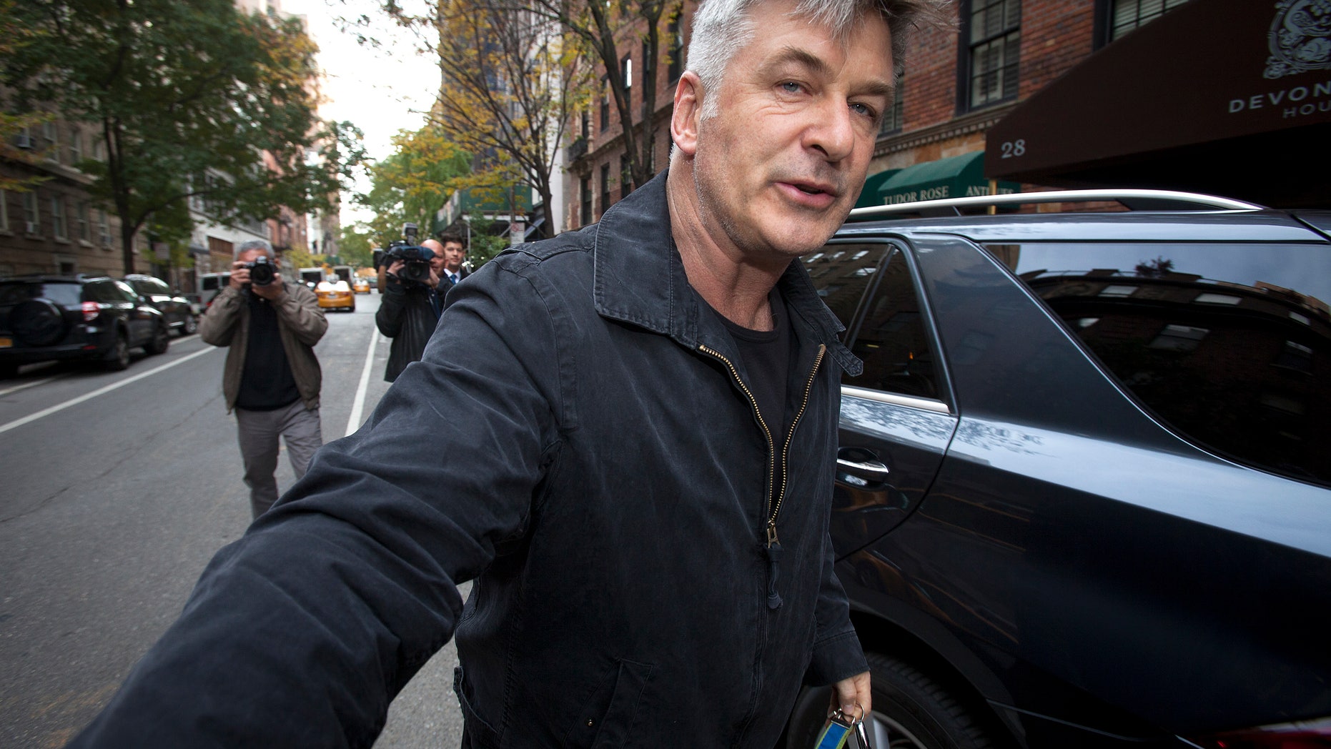 November 15, 2013. Actor Alec Baldwin shoves a photographer and tells him to move out of his way after he arrived in his SUV at the building where he lives in New York.
