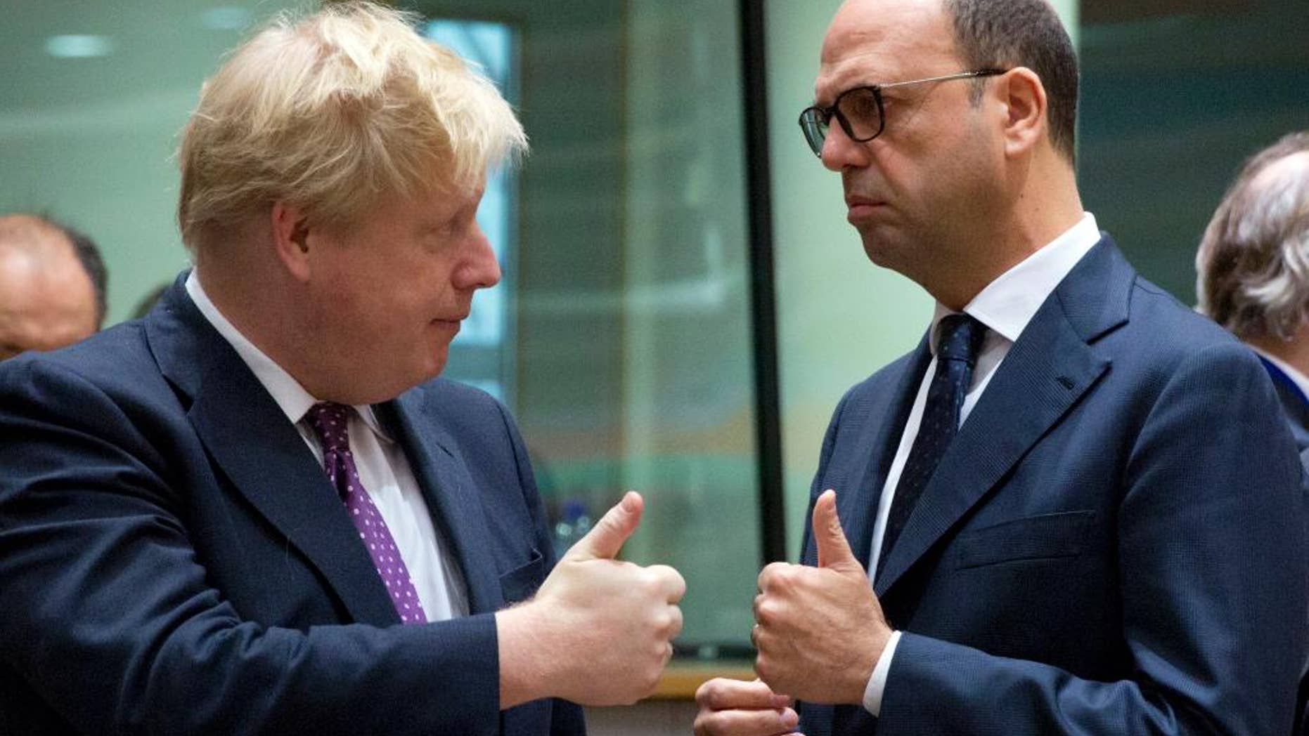 British Foreign Minister Boris Johnson, left, speaks with Italian Foreign Minister Angelino Alfano during a meeting of EU foreign ministers at the EU Council building on Monday, Feb. 6, 2017. (AP Photo/Virginia Mayo)