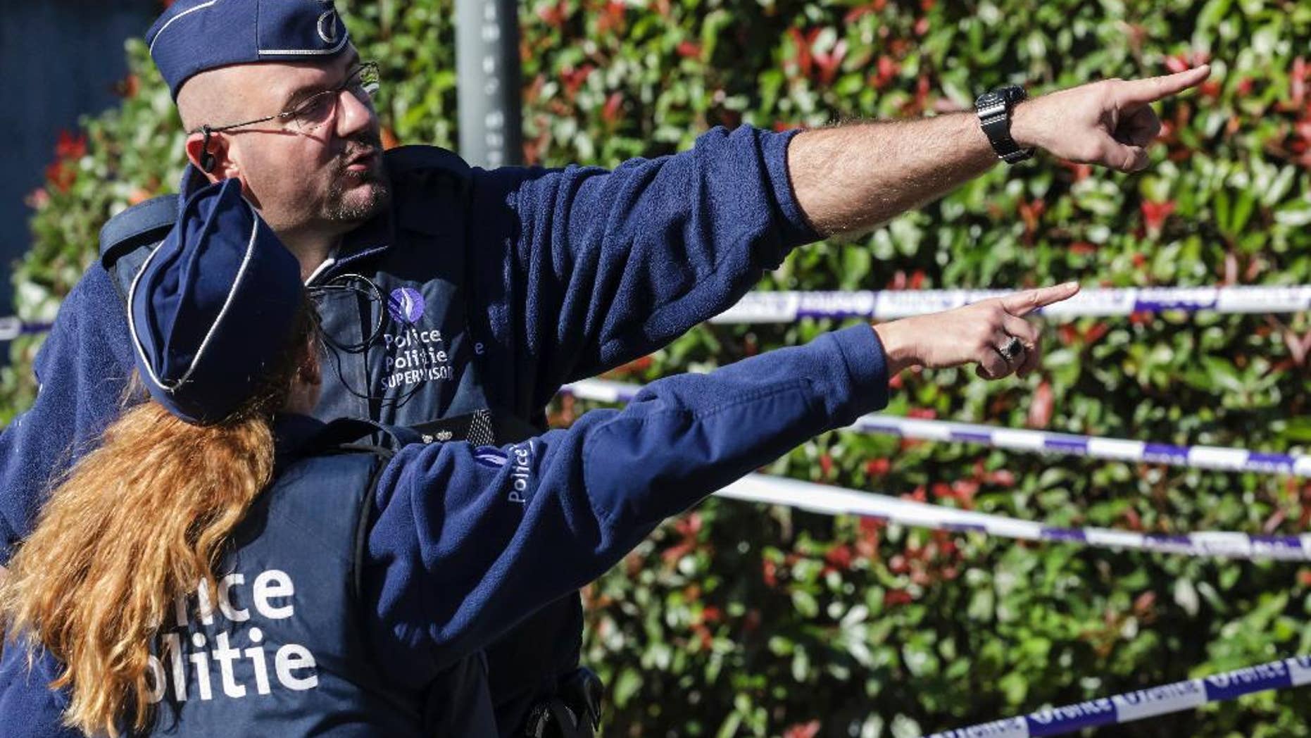 Police investigate the scene where a man stabbed two police officers, in the Schaerbeek neighborhood in Brussels, Wednesday, Oct. 5, 2016. The man stabbed one officer in the neck and the other in the abdomen and then fled the scene in an incident that Belgian prosecutors say could be terror-related. (AP Photo/Olivier Matthys)