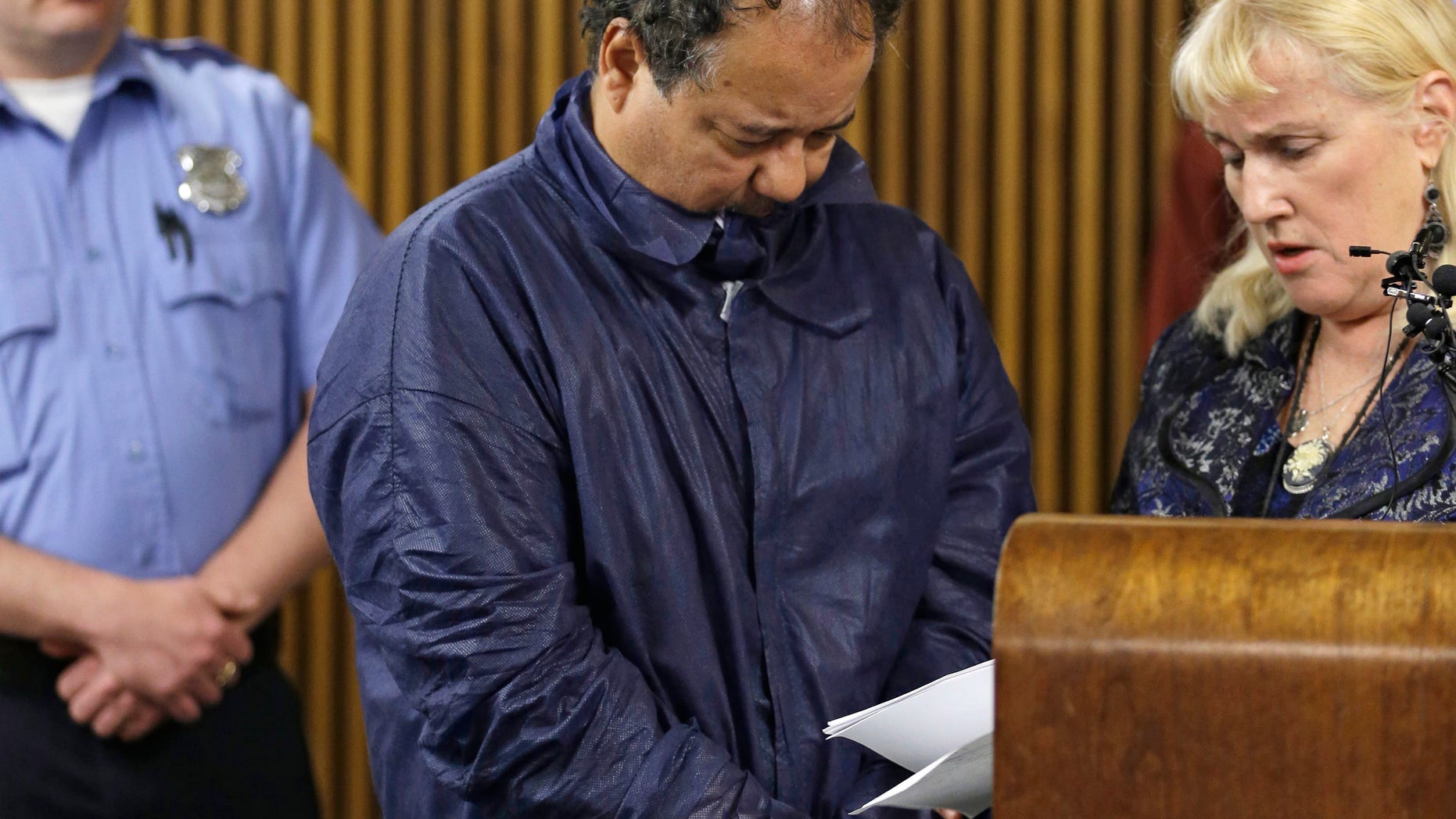 Ariel Castro appears in Cleveland Municipal court alongside defense attorney Kathleen DeMetz, right, Thursday, May 9, 2013, in Cleveland. Castro was charged with four counts of kidnapping and three counts of rape after three women missing for about a decade and one of their young daughters were found alive at his home earlier in the week. (AP Photo/Tony Dejak)