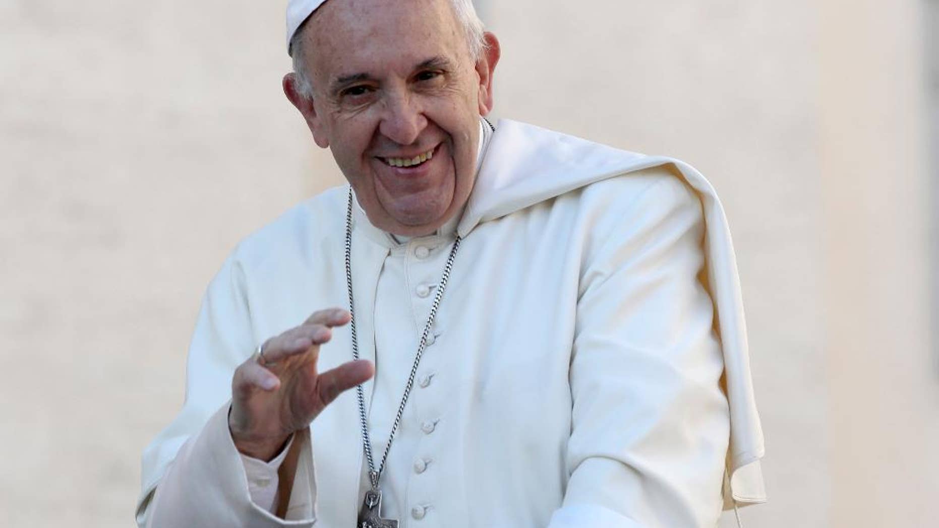 FILE - In this Oct. 19, 2016, file photo, Pope Francis waves to the crowd as he is driven around St. Peter's Square ahead of his weekly general audience, at the Vatican. Francis was presented by Chicago Archbishop Blase Cupich with a Chicago Cubs hat and what looks like a signed baseball at the Vatican Tuesday, Nov. 15, 2016, nearly two weeks after the Cubs won their first World Series since 1908. (AP Photo/Alessandra Tarantino, File)