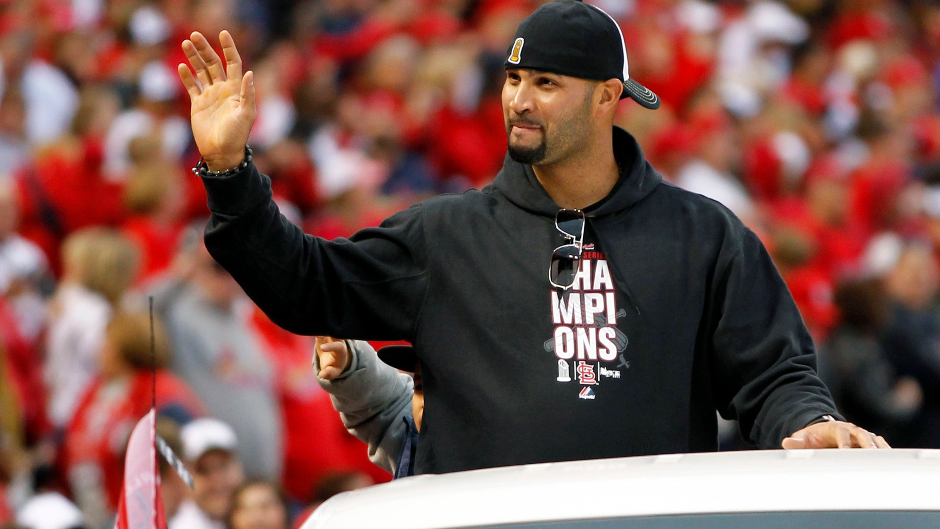 FILE - In this Oct. 30, 2011, file photo, former St. Louis Cardinals player Albert Pujols waves to fans at Busch Stadium during a parade in celebration of the Cardinals' 11th World Series victory in St. Louis. Pujols’ exit had no effect on the Cardinals, who have not missed the three-time NL MVP. (AP Photo/Jeff Roberson, File)