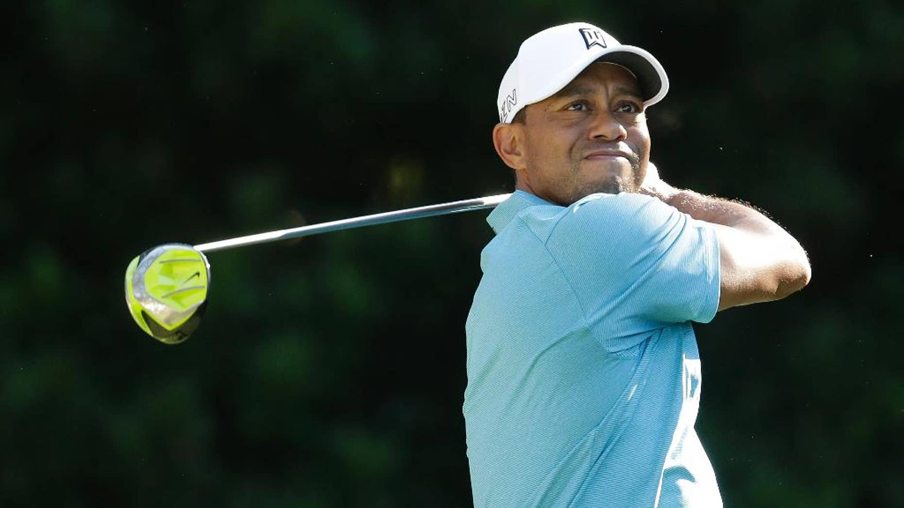 Tiger Woods follows his shot from the 11th tee during the second round of The Players Championship golf tournament Friday, May 8, 2015, in Ponte Vedra Beach, Fla. (AP Photo/Lynne Sladky)