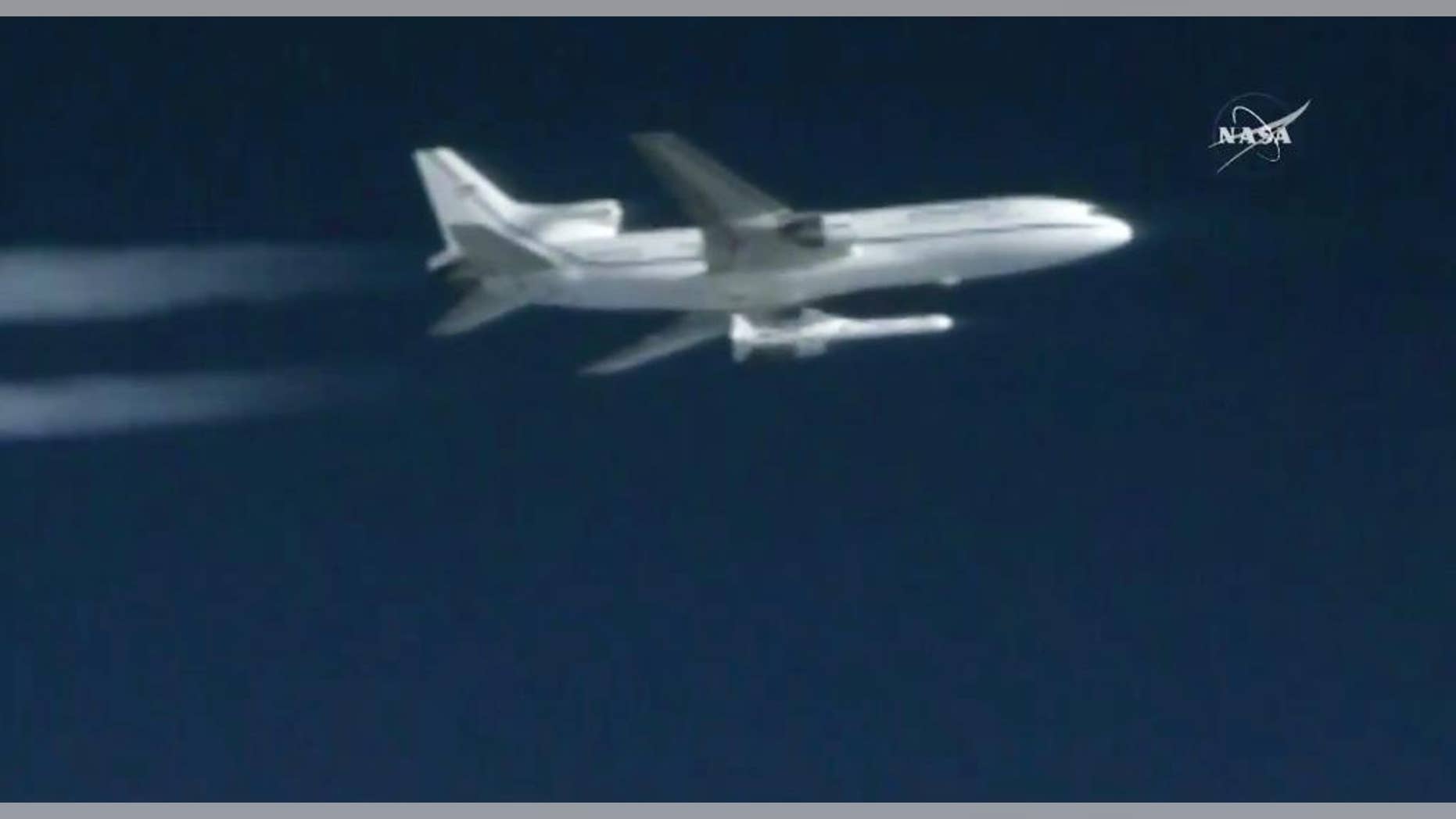 This still image taken from video provided by NASA, a Pegasus rocket containing eight mini-satellites is launched from a plane on Thursday, Dec. 15, 2016, 39,000 feet above the Atlantic, 100 miles east of Daytona Beach, Fla. Pegasus fired five seconds later, propelling the satellites toward orbit. The $157 million Cyclone Global Navigation Satellite System is meant to improve hurricane forecasting. (NASA via AP)