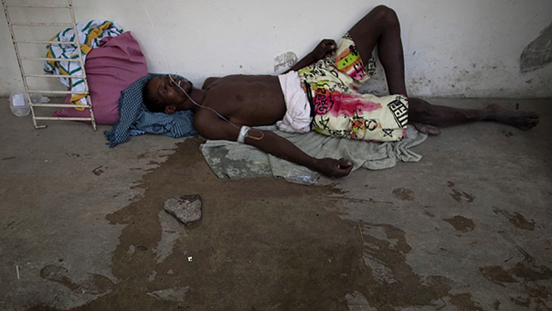 Oct. 22: A man suffering from cholera symptoms lies on the floor of the hospital in Marchand Dessalines, Haiti.