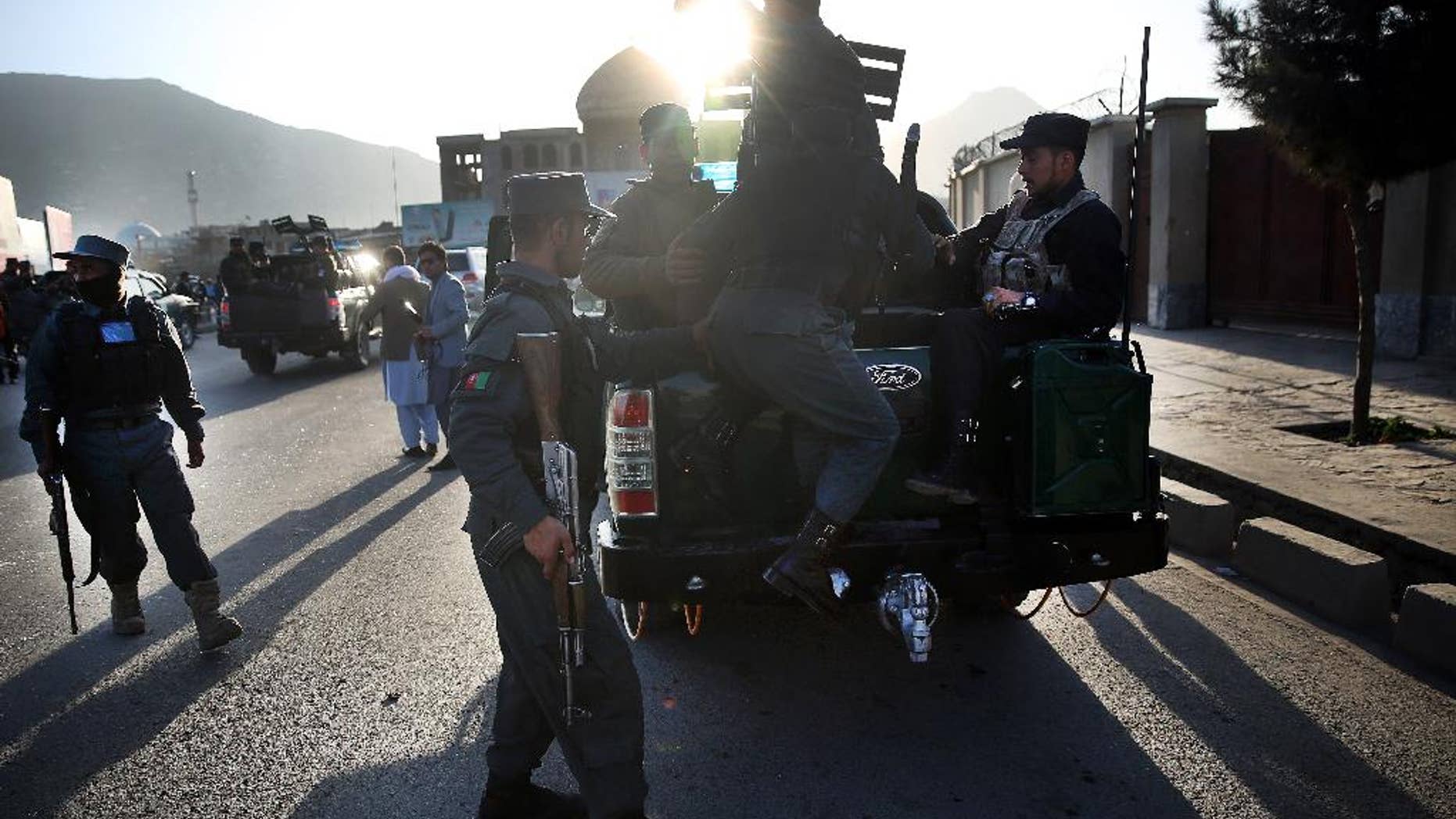 FILE - In this Saturday, Feb. 27, 2016 file photo, Afghan National Police soldier leave the site of a suicide attack near the Defense Ministry compound, in Kabul, Afghanistan. Senior members of the Afghan Taliban said on Thursday that a prominent figure within the militant group who had opposed its new leadership has now pledged his allegiance, helping to close divisions within the Taliban ahead of possible peace talks with the government. (AP Photos/Massoud Hossaini, File)