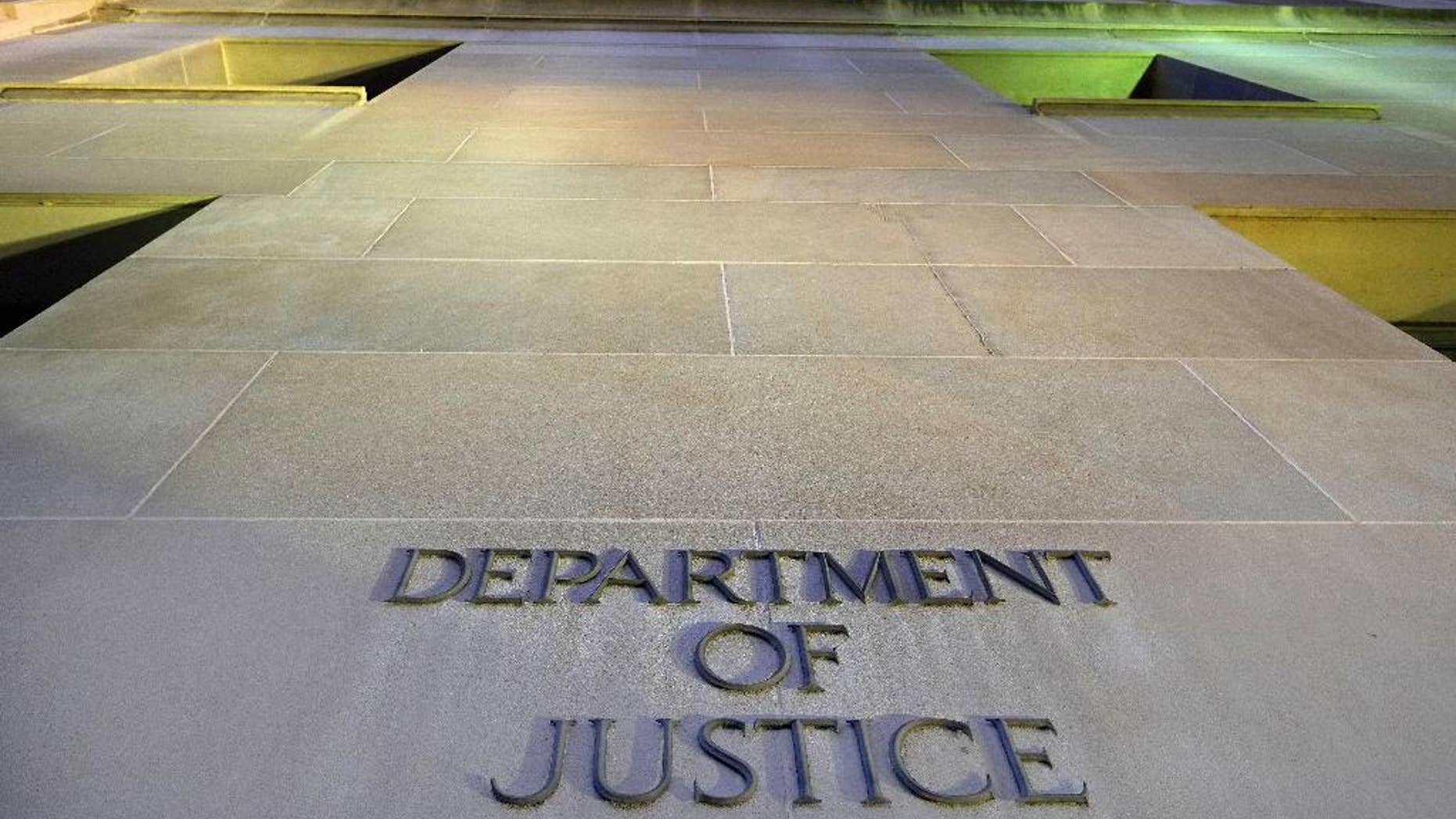 FILE - In this May 14, 2013, file photo, the Department of Justice headquarters building in Washington is photographed early in the morning. The Justice Department has signaled that it won’t try to block a lawsuit arising from the CIA’s harsh interrogation techniques, leaving the door open for a court challenge over tactics that have since been discontinued and widely discredited. (AP Photo/J. David Ake, File)