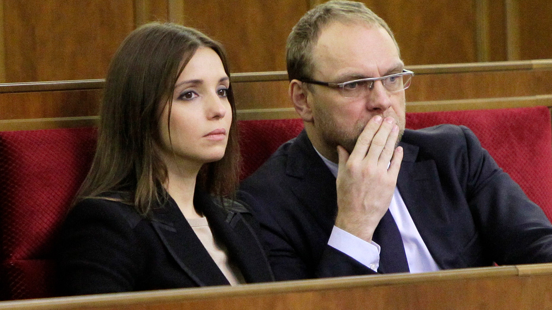 ADDS THAT THE OPPOSITION LATER SAID THAT HE WAS BEING QUESTIONED AND IS NOT ARRESTED FILE - In this Nov. 8, 2013 file photo, Eugenia Tymoshenko, daughter of imprisoned former Ukrainian Prime Minister Yulia Tymoshenko,left, and Serhiy Vlasenko, the lawyer of former Prime Minister Yulia Tymoshenko watch a parliament session in Kiev, Ukraine. Opposition leader Arseniy Yatsenyuk told a parliamentary committee hearing on Monday Nov. 11, 2013, that he has received a text message from Serhiy Vlasenko saying that he has been arrested, according to Yatsenyuk’s spokeswoman Olha Lappo. Tymoshenko’s office could not immediately confirm the arrest. Yatsenyuk said later that the opposition was reassured by a top prosecutor that Vlasenko is not arrested but is being questioned.(AP Photo/Sergei Chuzavkov, File)