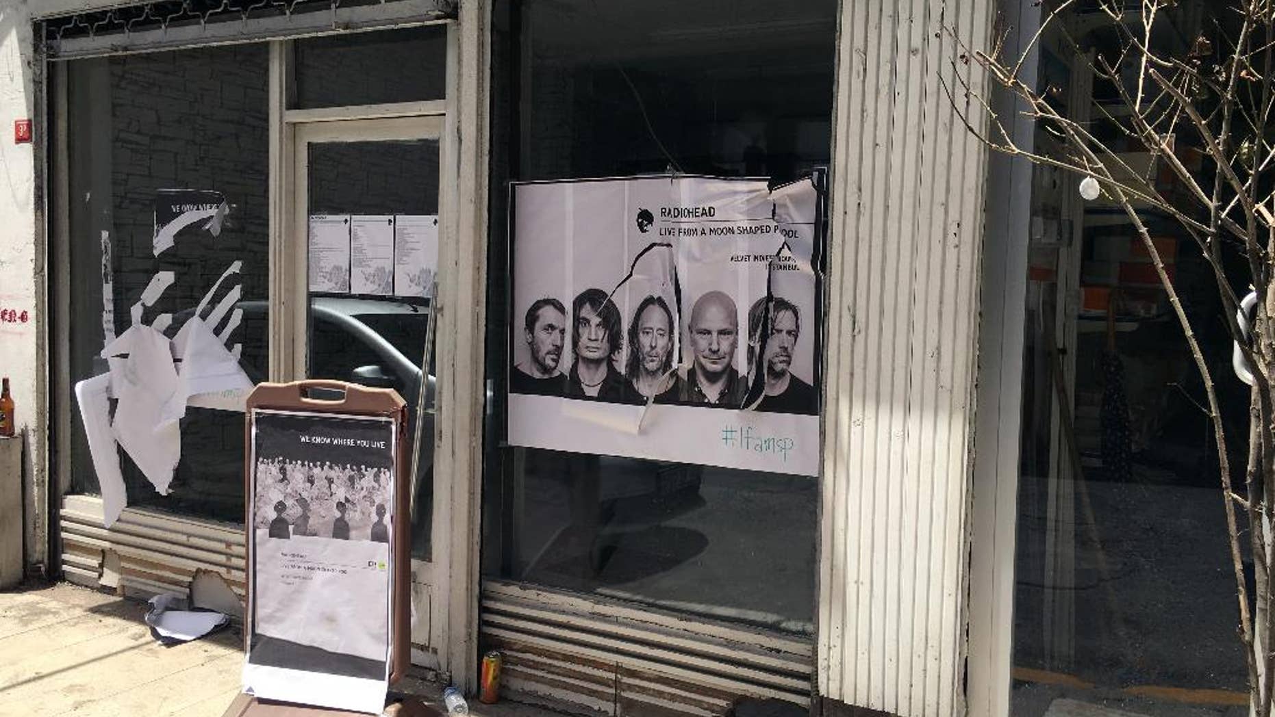 A ripped up poster advertising the streaming event of Radiohead's new album, at a record shop, in Istanbul, Saturday, June 18, 2016. Turkish media report a mob of 20 assailants carrying sticks and bottles attacked Radiohead fans who had gathered at a record store in Istanbul to listen to the band's new album. The private Dogan news agency reported Saturday that one person was wounded in the incident Friday at the Velvet Indieground record shop. (AP Photo/Dominique Soguel)