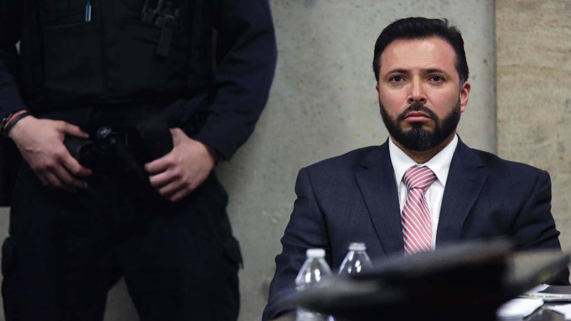 In this Monday, April 20, 2015 photo, Chicago police Detective Dante Servin listens as Judge Dennis Porter reads his decision at the Leighton Criminal Court Building in Chicago on involuntary manslaughter charges in the March 2012 shooting death of Rekia Boyd. Porter ruled that prosecutors failed to prove Servin acted recklessly, by the legal definition. Demonstrators rallied Monday night to protest the acquittal. (John J. Kim/Chicago Tribune via AP, Pool)