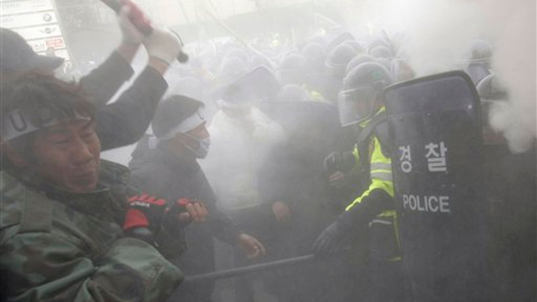 Nov. 27: Former South Korean underwater demolition team members clash with riot policemen as they spray fire extinguishers during an anti-government rally in front of the Defense Ministry in Seoul, South Korea.