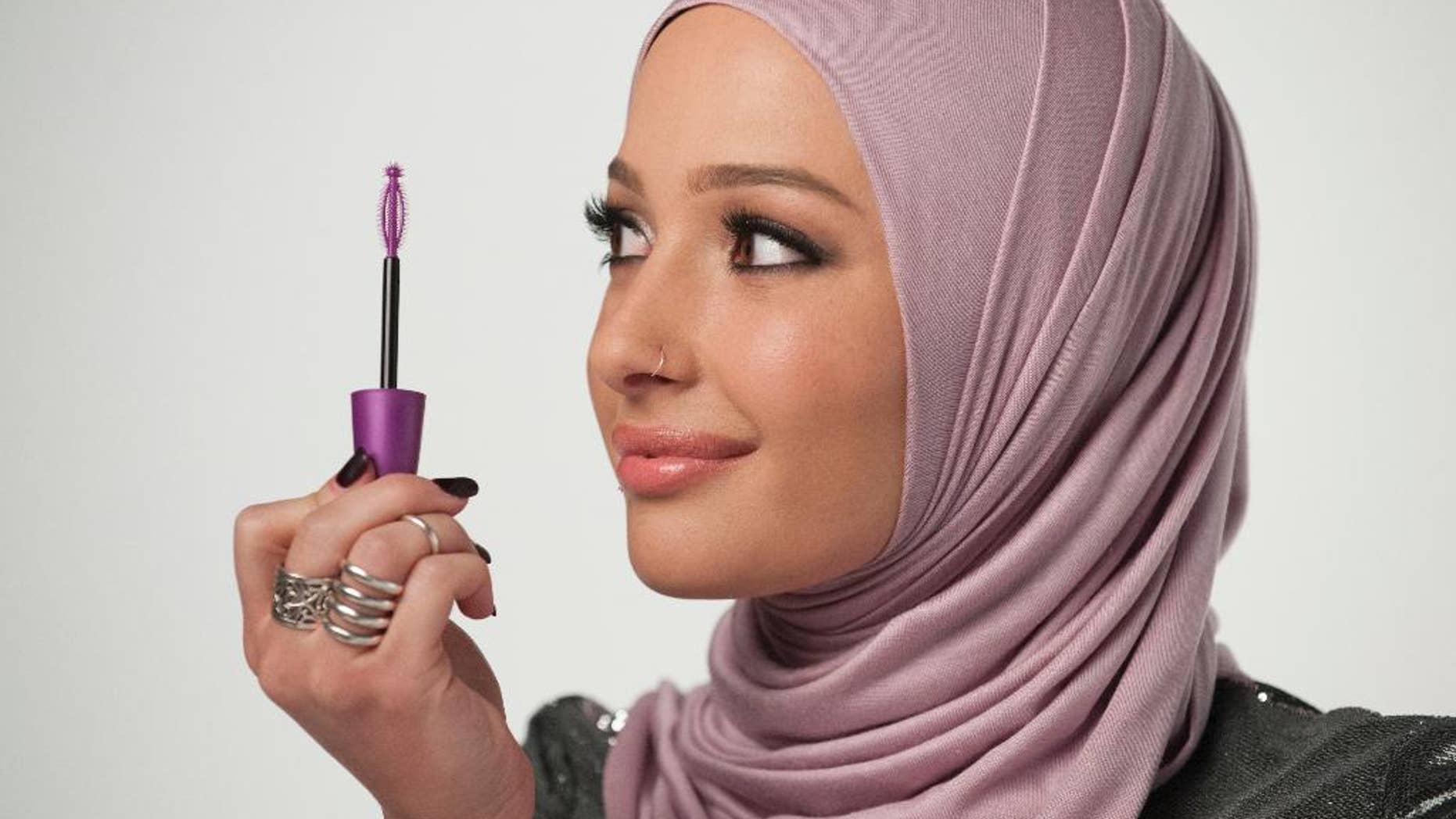 In this undated photo provided by CoverGirl, beauty blogger Nura Afia poses for a photo. CoverGirl is featuring a woman wearing a hijab in its advertising for the first time in the makeup line’s history. (Lacey Terrell/CoverGirl via AP)