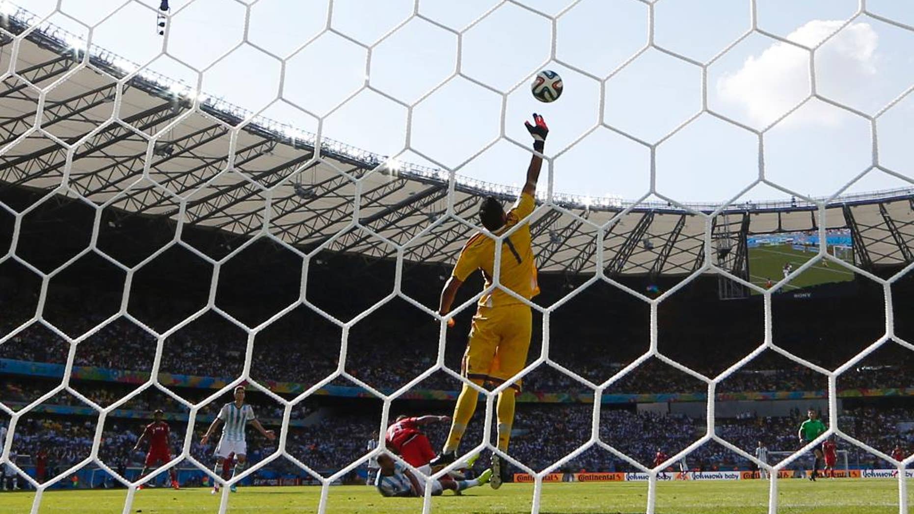 Argentina's goalkeeper Sergio Romero deflects a header by Iran's Ashkan Dejagah over the goal during the group F World Cup soccer match between Argentina and Iran at the Mineirao Stadium in Belo Horizonte, Brazil, Saturday, June 21, 2014. (AP Photo/Fernando Vergara)