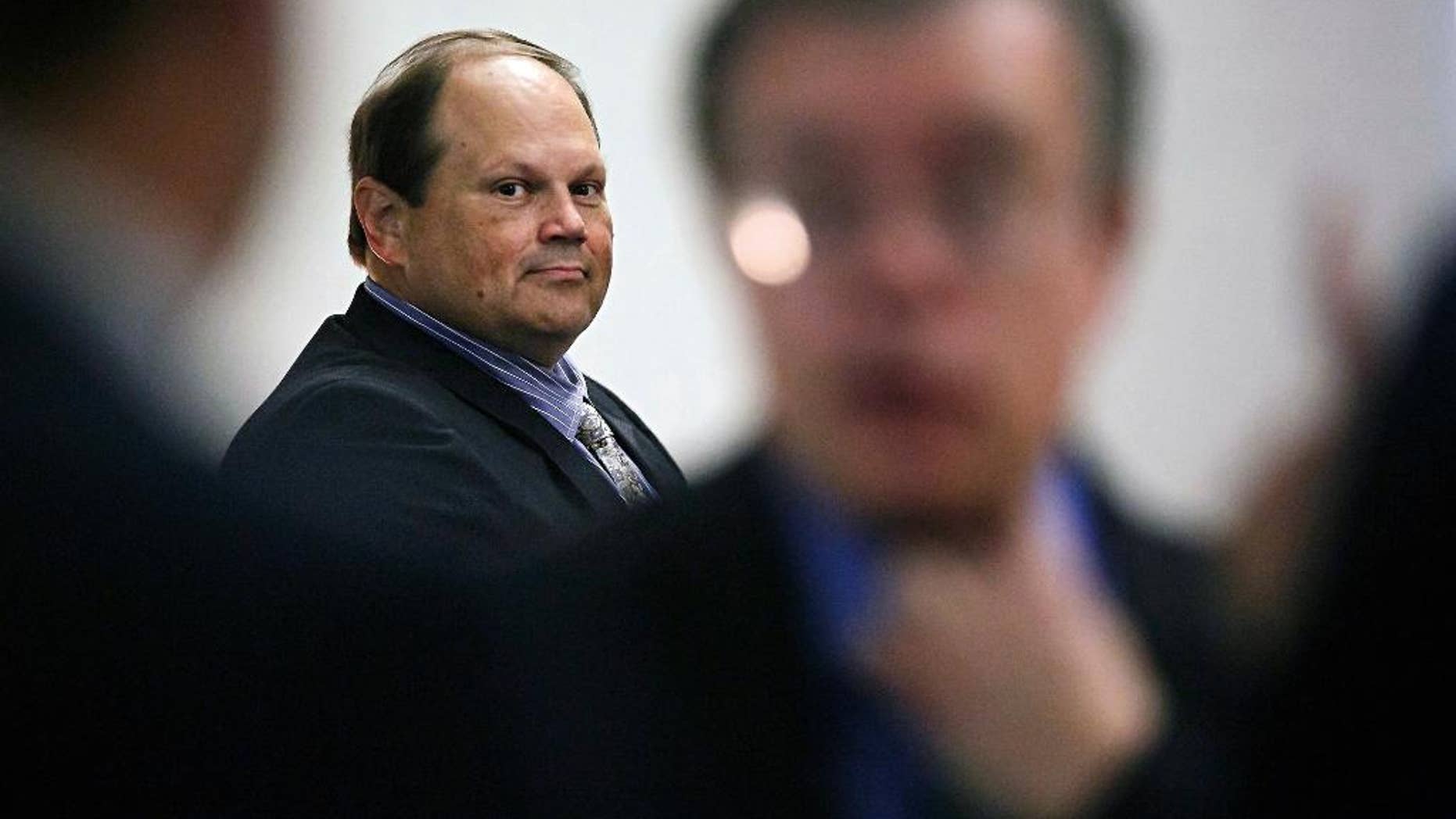 FILE - In this July 15, 2015 file photo, Eddie Tipton, former security director of the Multi-State Lottery Association, looks toward his lawyers before the start of his trial in Des Moines, Iowa. A group of state lotteries has asked a judge to dismiss a lawsuit filed by a jackpot winner who argues he was shortchanged by millions of dollars because the prior drawing was rigged by one of its employees. Tipton has been convicted of rigging a $16.5 million jackpot in December 2010. (Brian Powers/The Des Moines Register via AP) MAGS OUT, TV OUT, NO SALES, MANDATORY CREDIT