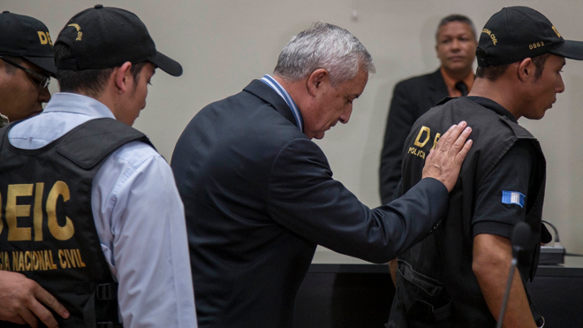 Former President of Guatemala Otto Perez Molina, center, is escorted by police detectives on his way to jail, after a court hearing where he faces corruption charges, in Guatemala City, Thursday, Sept. 3, 2015. Perez Molina was detained overnight before the hearing was to resume Friday morning. Judge Miguel Angel Galvez cited a need to âensure the continuity of the hearingâ and guarantee the former presidentâs personal safety. (AP Photo/Luis Soto)