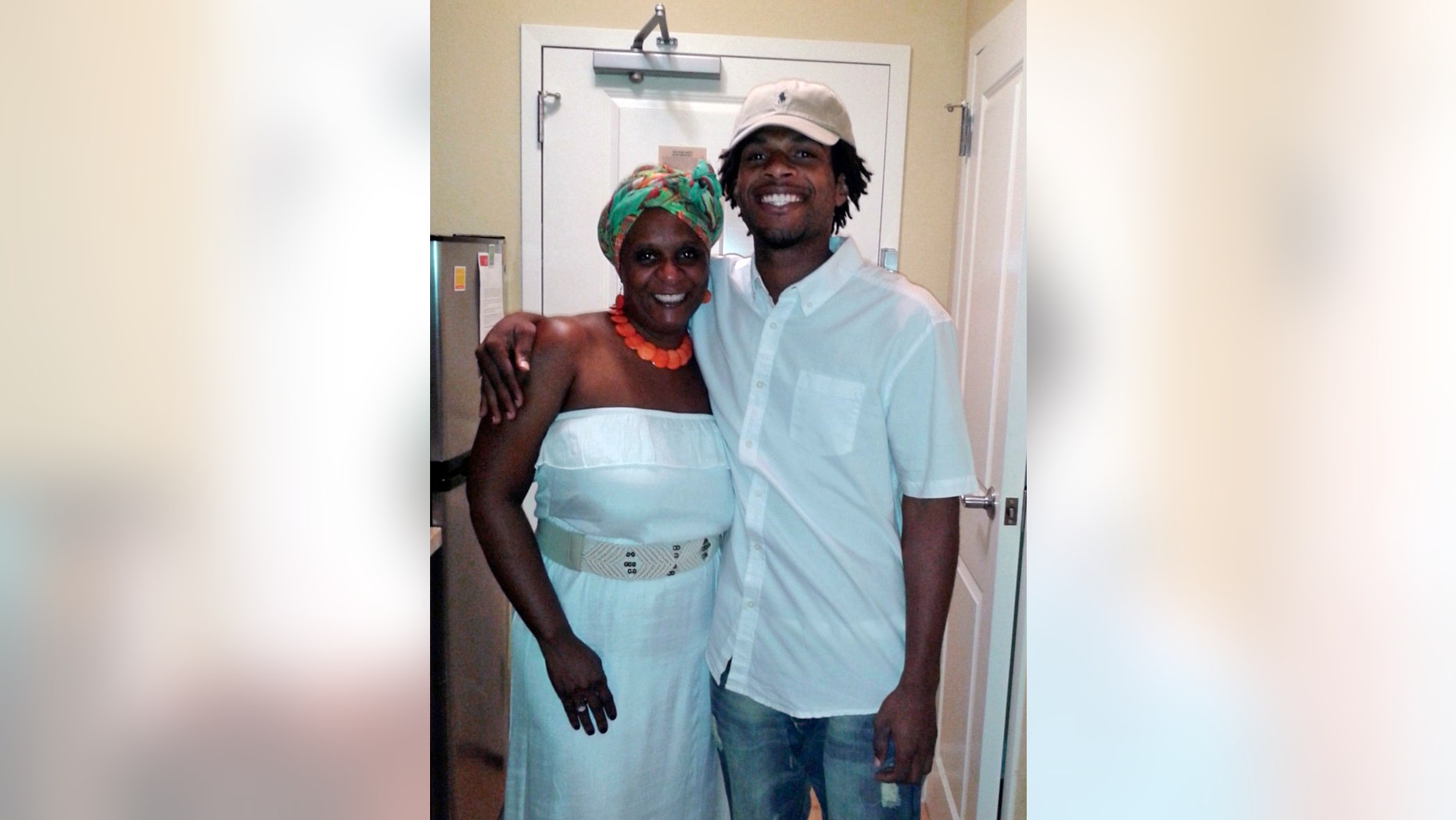 This undated photo provided by the family of John Crawford III shows Crawford, right, with his mother, Tressa Sherrod. A special grand jury will look into the fatal shooting of Crawford by police in an Ohio Wal-Mart and will be asked to determine whether any charges should be filed in the case that has drawn national attention to the southwestern Ohio city. (AP Photo/Courtesy family of John Crawford III)