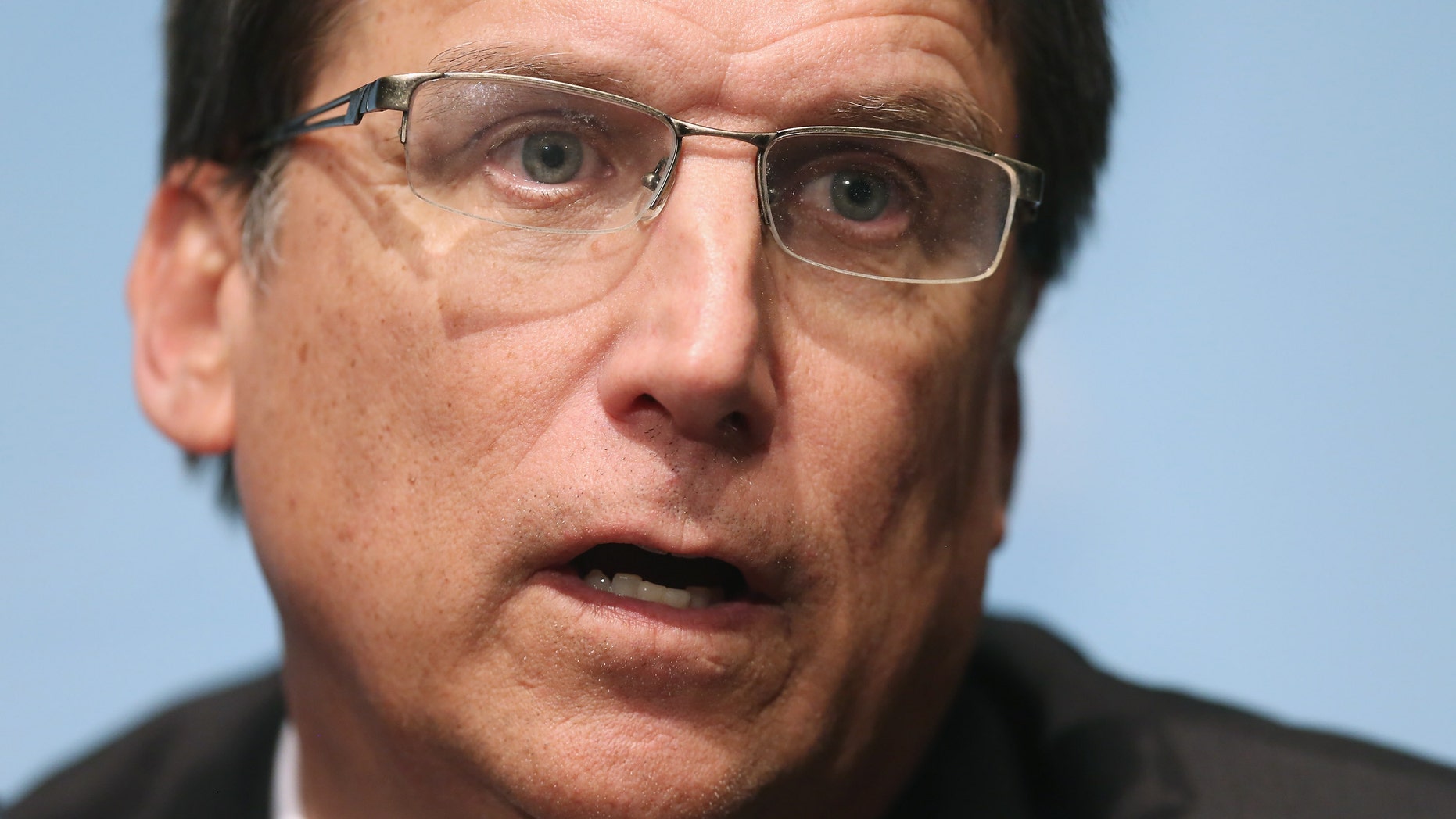 North Carolina Gov. Pat McCrory said a man who looked like a "former championship wrestler" bashed his car with a large tree limb.