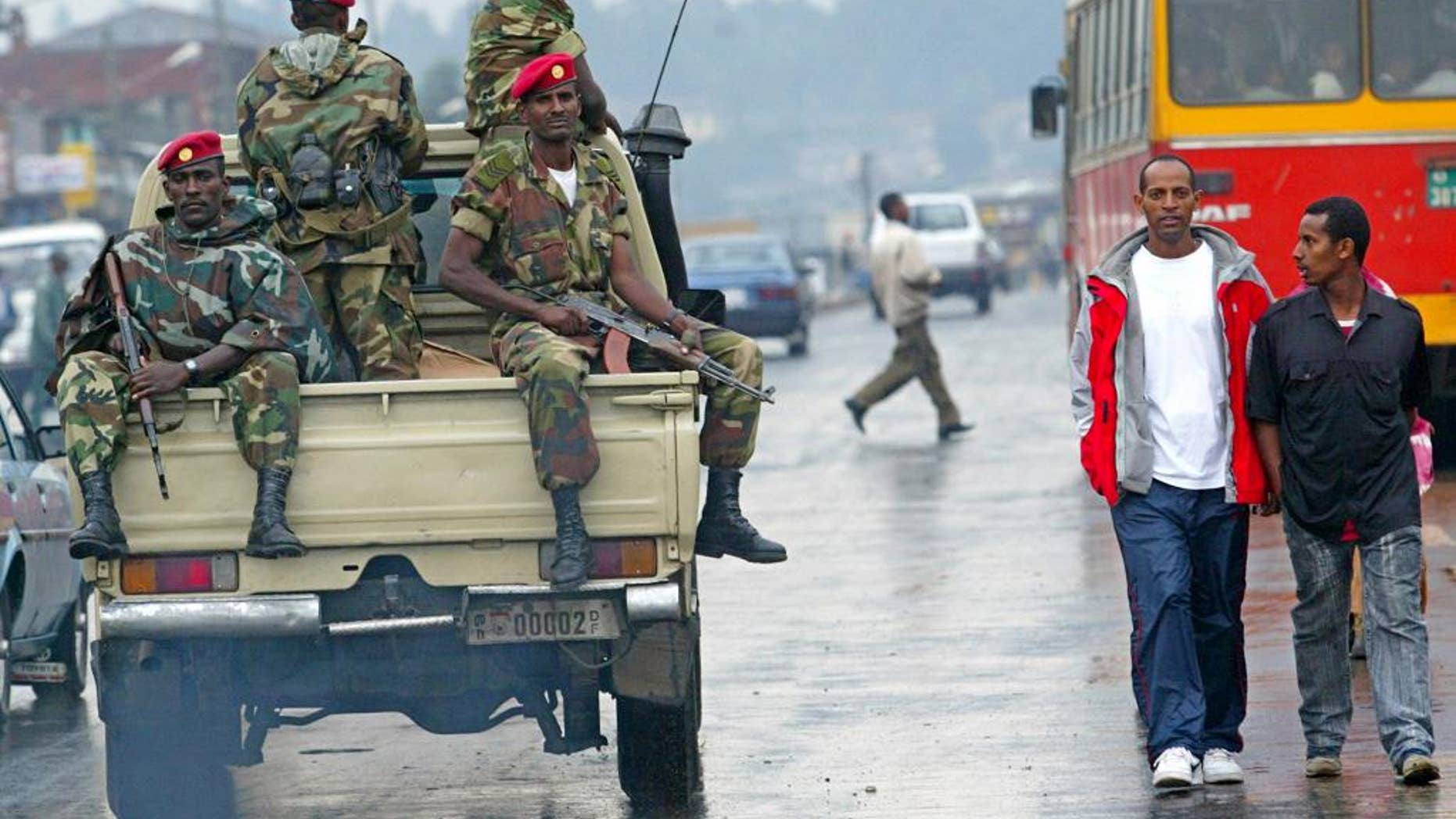 FILE - In this June 10, 2005 file photo, members of the Ethiopian army patrol the streets of Addis Ababa, Ethiopia, after recent clashes with protesters. Violent weekend clashes between protesters and security forces have claimed the lives of more than a dozen people across Ethiopia. The government announced Sunday, Aug. 7, 2016 that seven protesters died in the northern Amhara region's capital, Bahir Dar. Witnesses who spoke to The Associated Press anonymously for fear of reprisals said anti-riot police also used force Saturday to disperse hundreds of protesters in the capital, Addis Ababa.(AP Photo/Karel Prinsloo, file)