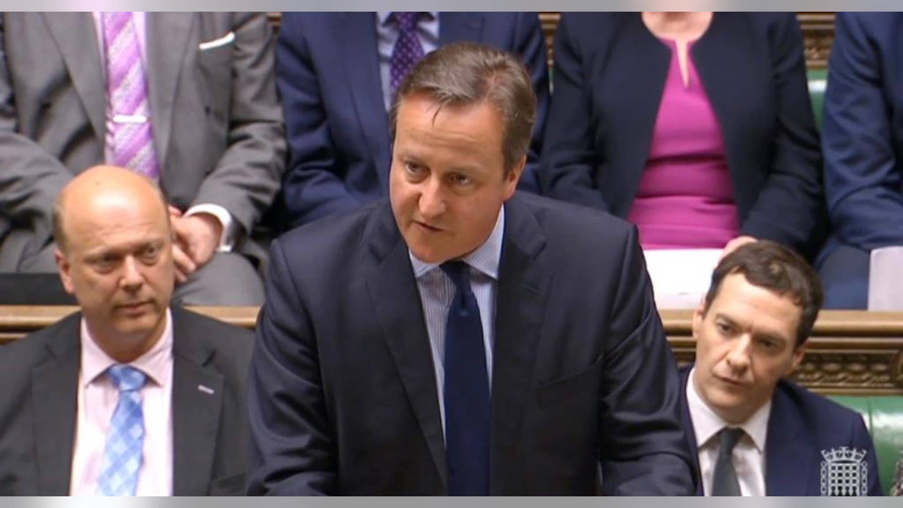 In this image taken from House of Commons TV, Britain's Prime Minister David Cameron makes a statement to the House of Commons over his personal finances, in London, Monday, April 11, 2016, with Chancellor of the Exchequer George Osborne, right, and senior Conservative Member of Parliament Chris Grayling, left. Under mounting pressure to reveal his financial background after days of damaging headlines, Cameron is trying to restore his government’s shaken reputation for competence with a statement in the House of Commons. (House of Commons TV / PA via AP) House of Commons logo bottom right from source.