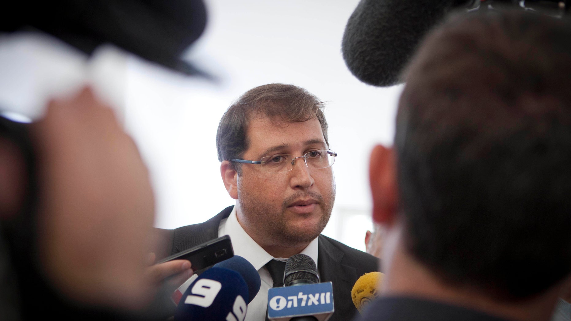 In this Tuesday, Dec. 17, 2013 photo, Israeli lawyer Michael Sfard talks to media after a court hearing at Israel's Supreme Court in Jerusalem. Sfard has emerged as one of the most effective defenders of Palestinian rights, arguing and winning high-profile cases in Israel's Supreme Court. Major victories include forcing the government to dismantle a large rogue settlement in the West Bank and rerouting Israel's separation barrier along some stretches to restore farmland to Palestinian villages. (AP Photo/Dan Balilty)
